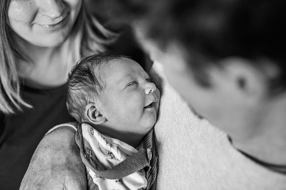 Artistic black and white photograph capturing an intimate family moment.