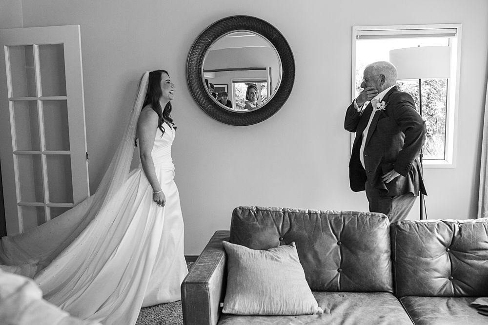 Black and white wedding preparation scene in an elegant room with natural light.
