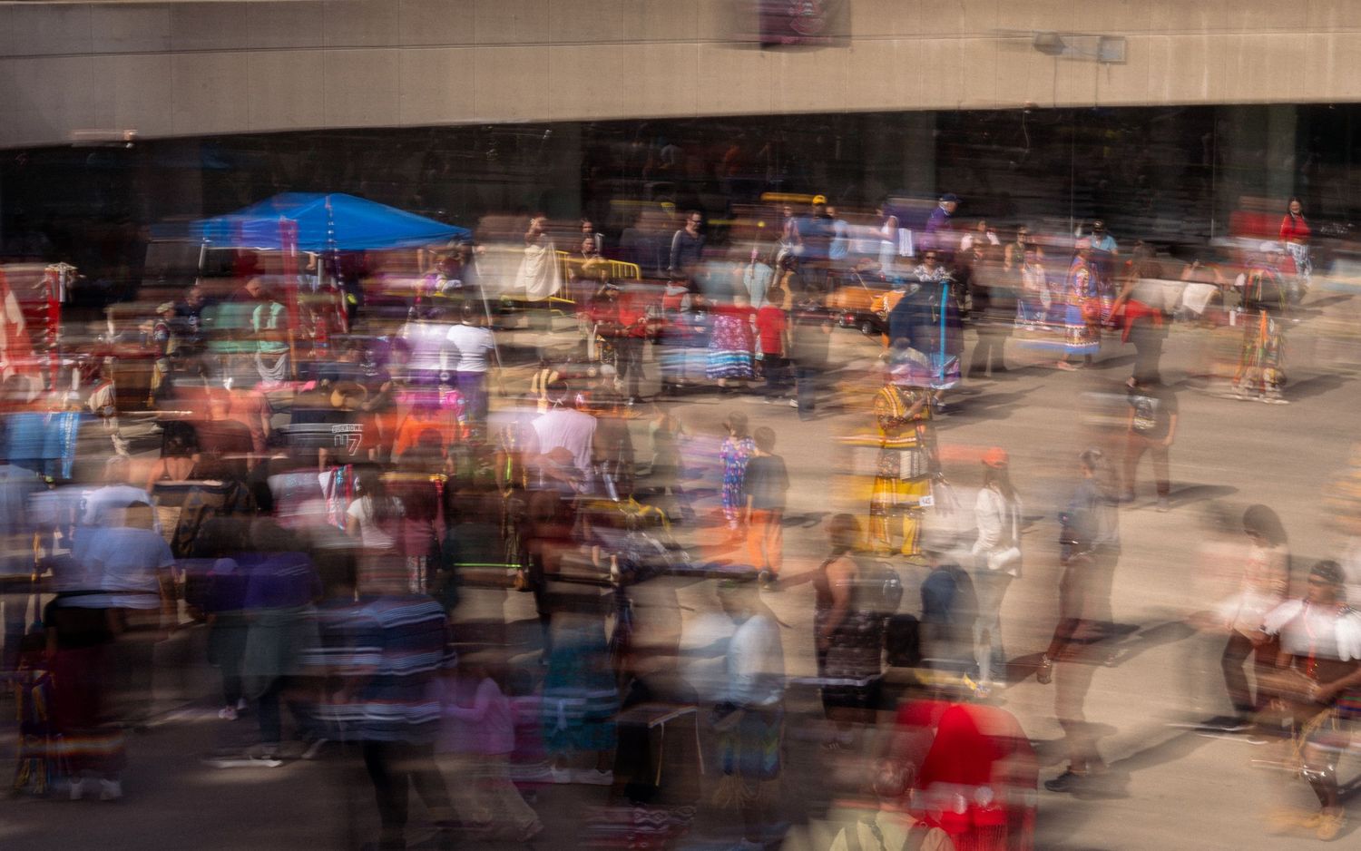 Long exposure photograph showing blurred movement of vehicles and lights on a busy street at dusk.