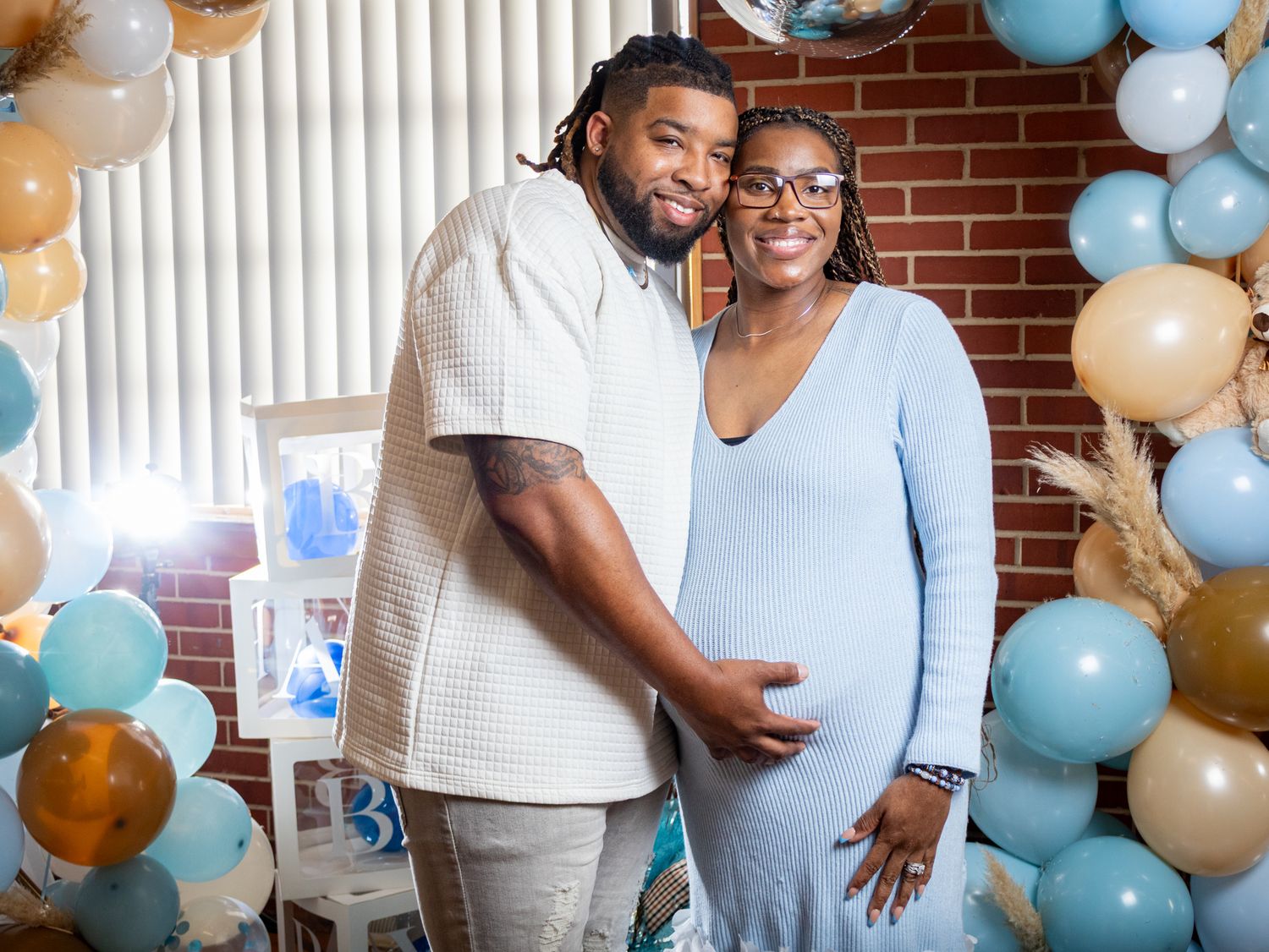 The Parents Posing for the camera excited for their new baby boy arrive at their baby shower. by zmoovy milestones