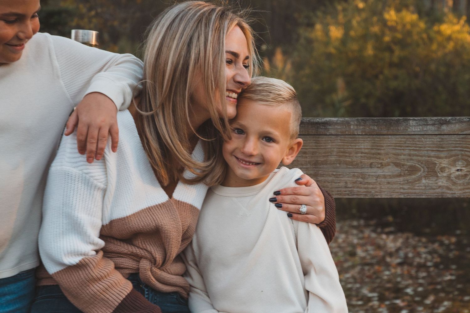 Outdoor family photo in Macomb, Michigan featuring mom and son sharing a sweet moment during a relaxed lifestyle photography session.