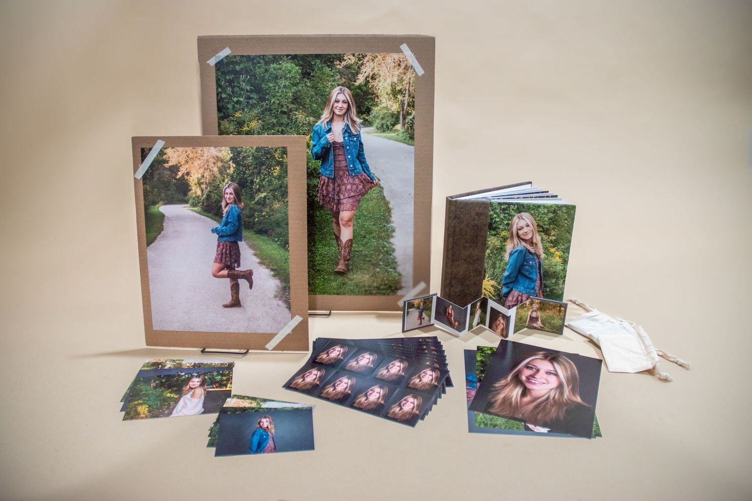 Senior session final products displayed, including album, large prints, and keepsakes, featuring a Dakota High student from Chippewa Valley