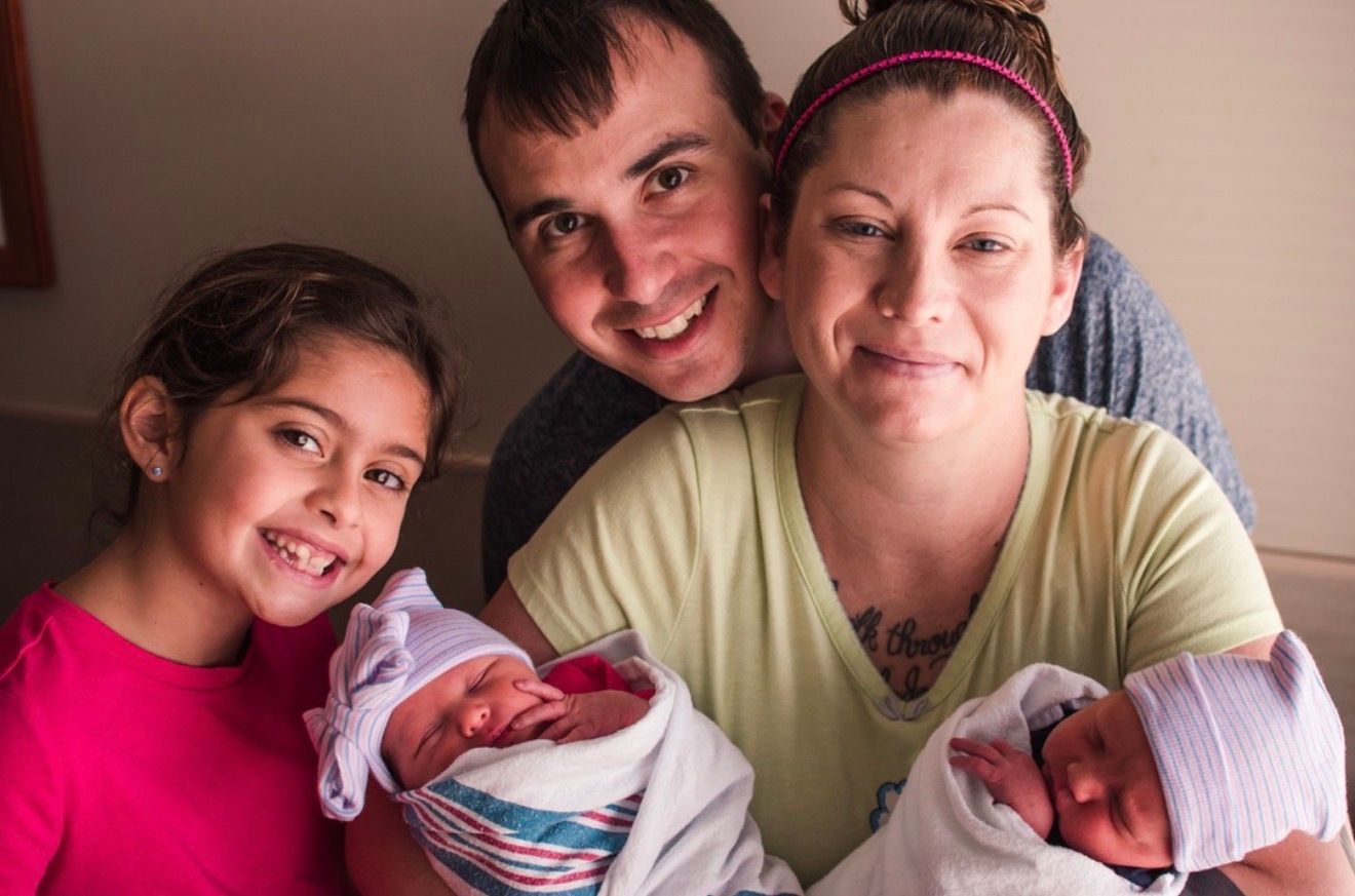 Parents and big sister pose with their brand new twin babies for a fresh 48 session at Beaumont Royal Oak of Michigan.