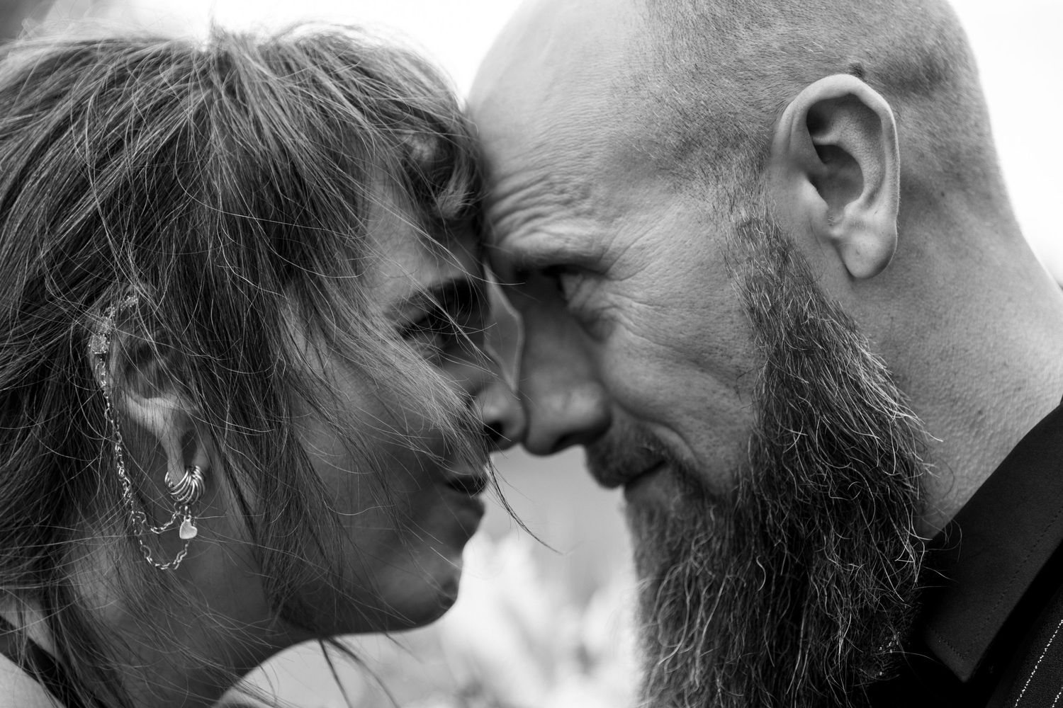 A series of intimate black and white close-up photos showing tender romantic moments between two people.