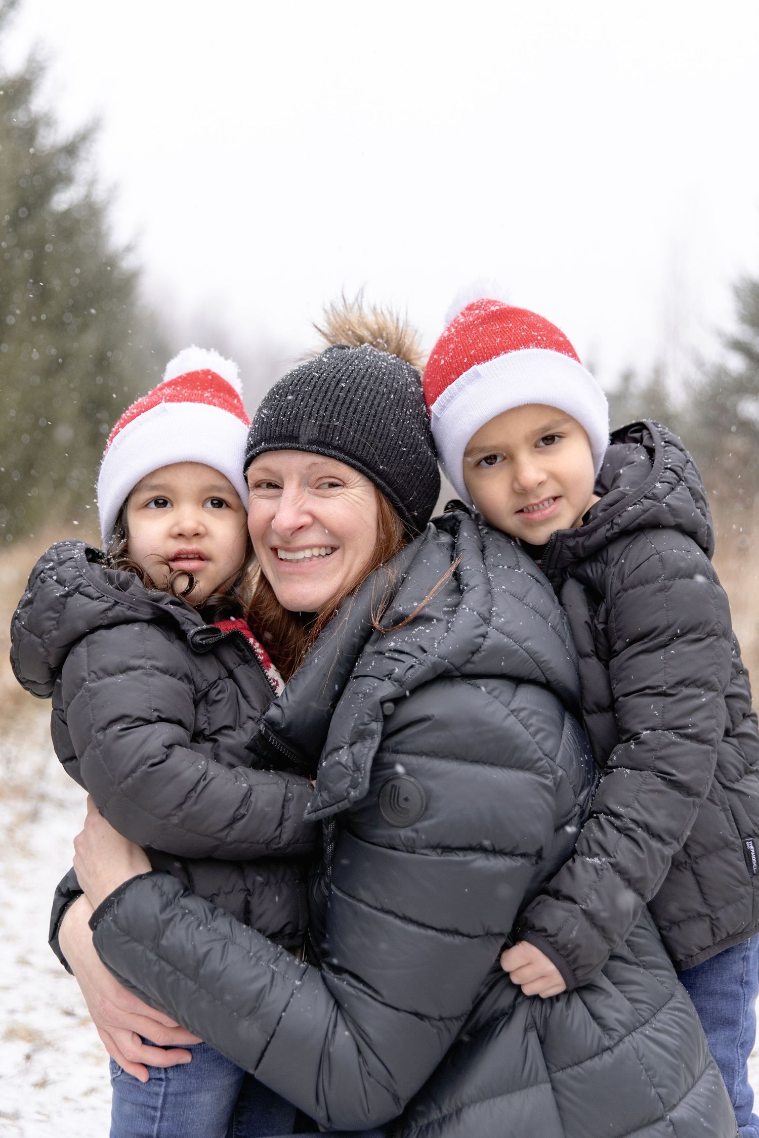 A series of winter photos showing people wearing warm coats and winter hats embracing in the snow.
