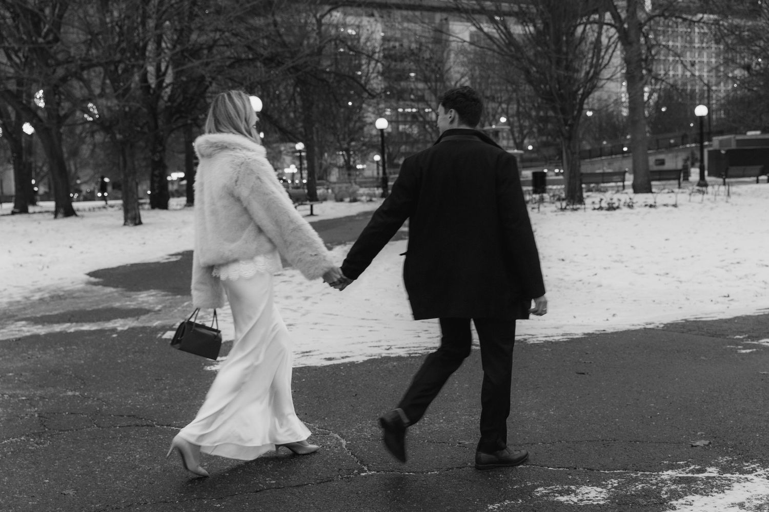 A black and white photo series showing a couple walking together in a snowy winter park setting.