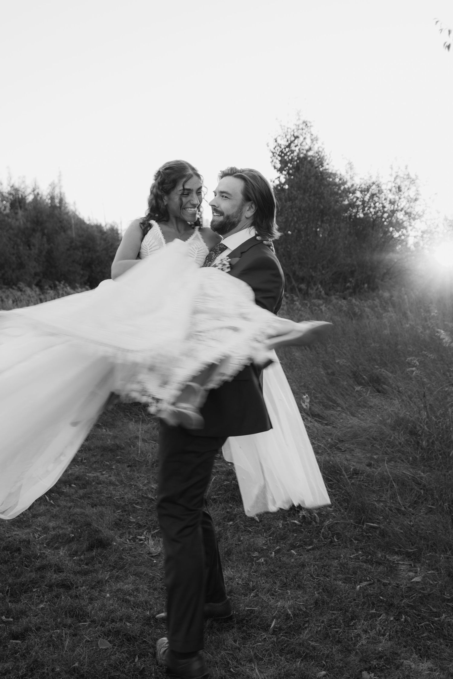 A black and white photo sequence shows a couple dancing and twirling with a flowing white veil in a meadow.