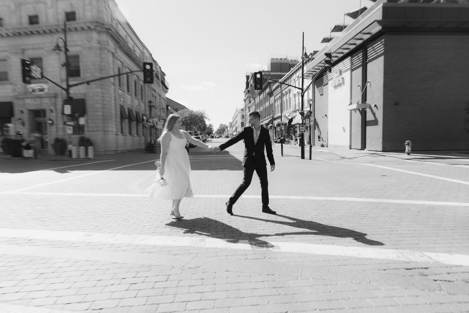 A series of black and white street photography images showing people walking through urban environments in harsh sunlight.