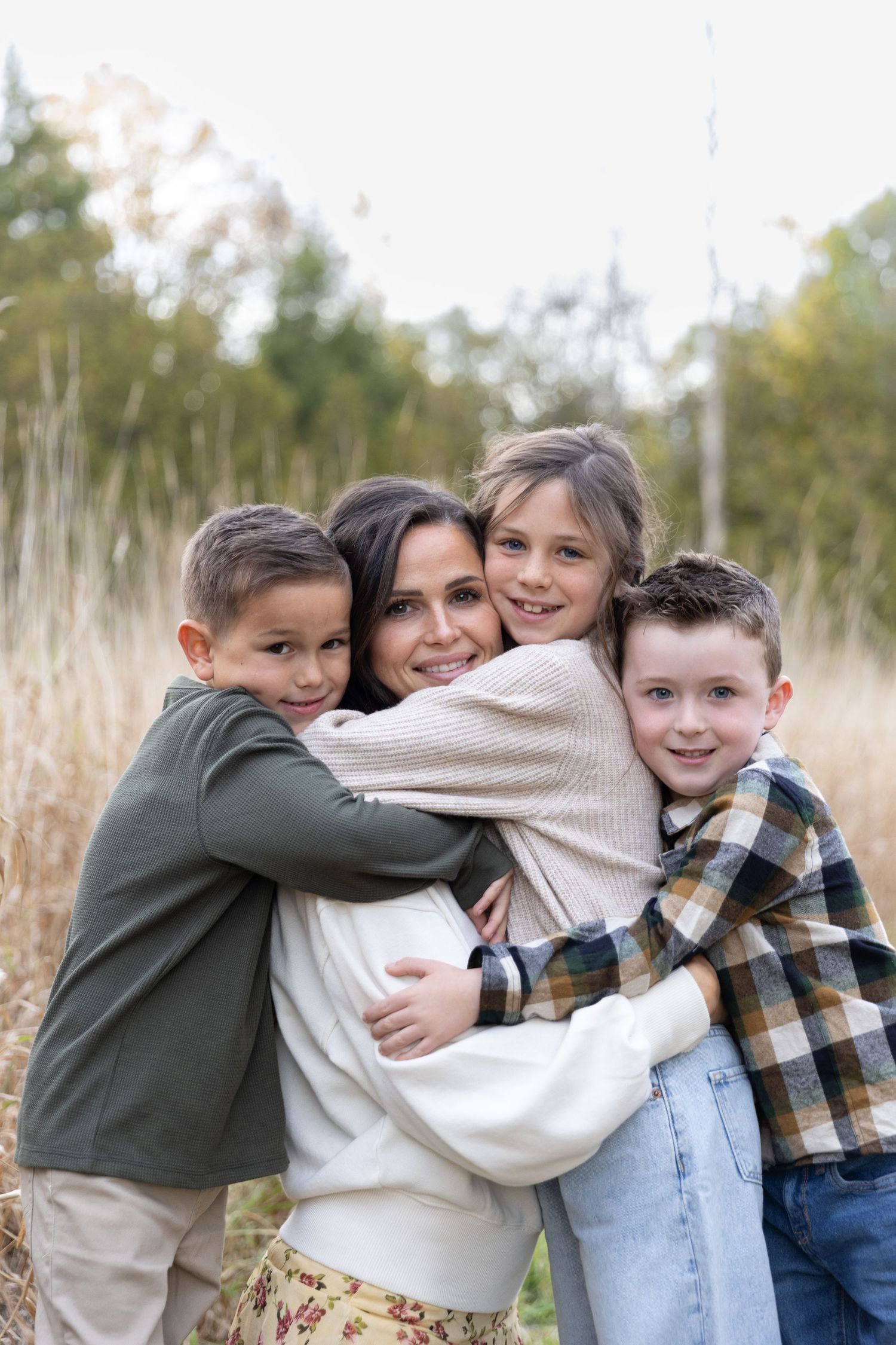 A heartwarming sequence of candid family photos showing embraces and hugs in an outdoor natural setting.