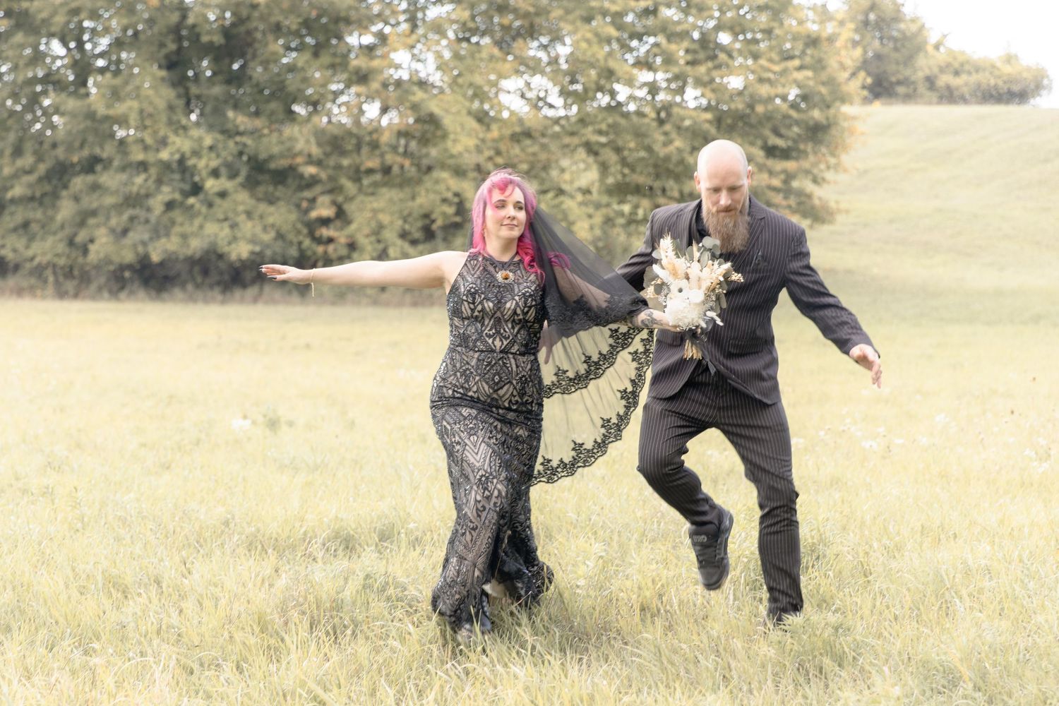 Two people playfully run through a grassy field while holding hands in a series of action shots.