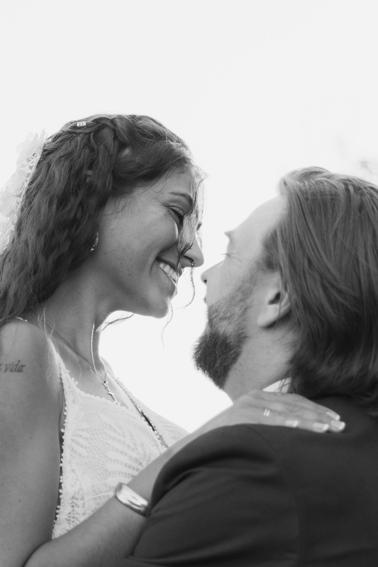 A romantic black and white photo sequence showing a couple in an intimate embrace and passionate kiss.