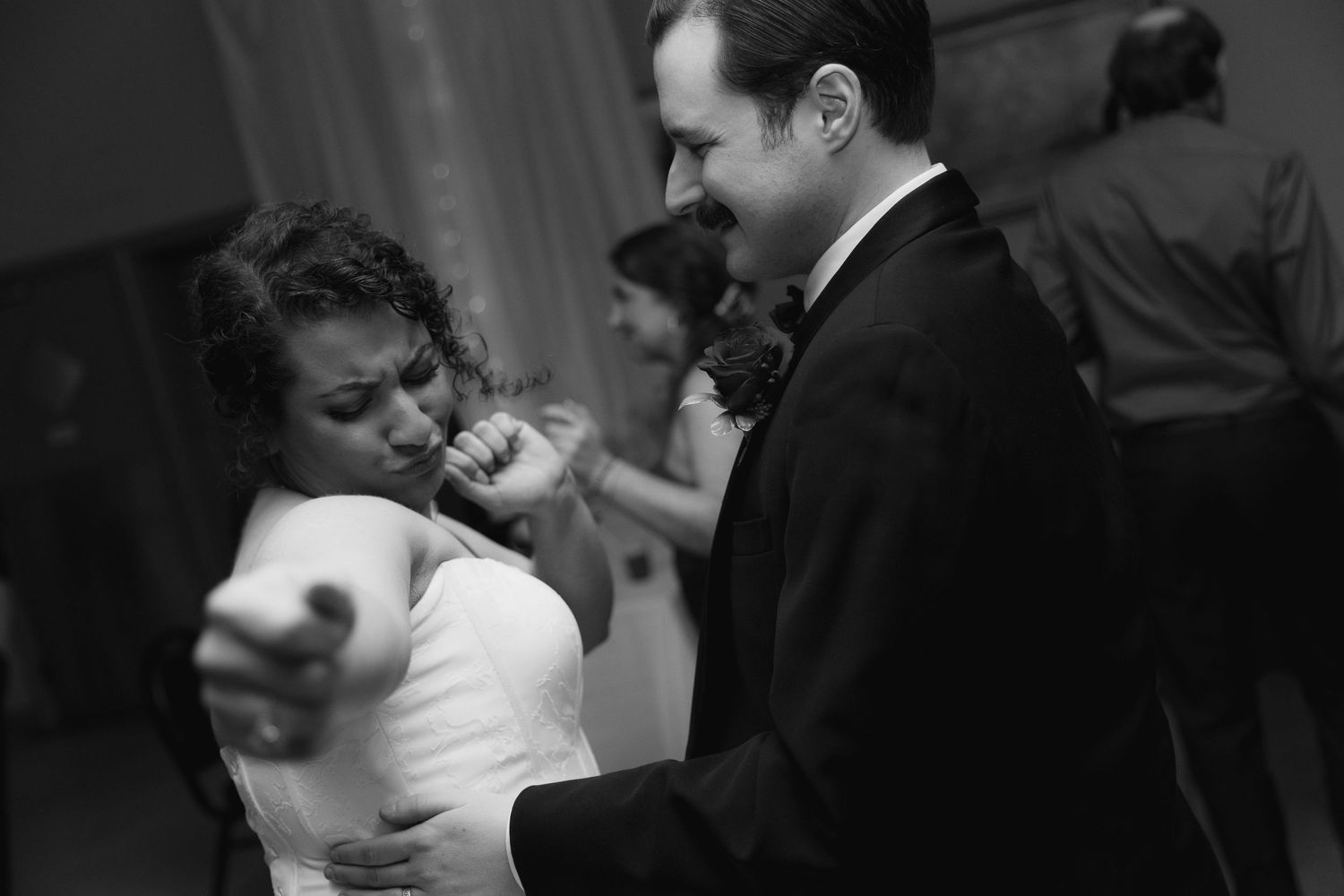 A series of black and white wedding photos showing romantic moments between newlyweds during their celebration.