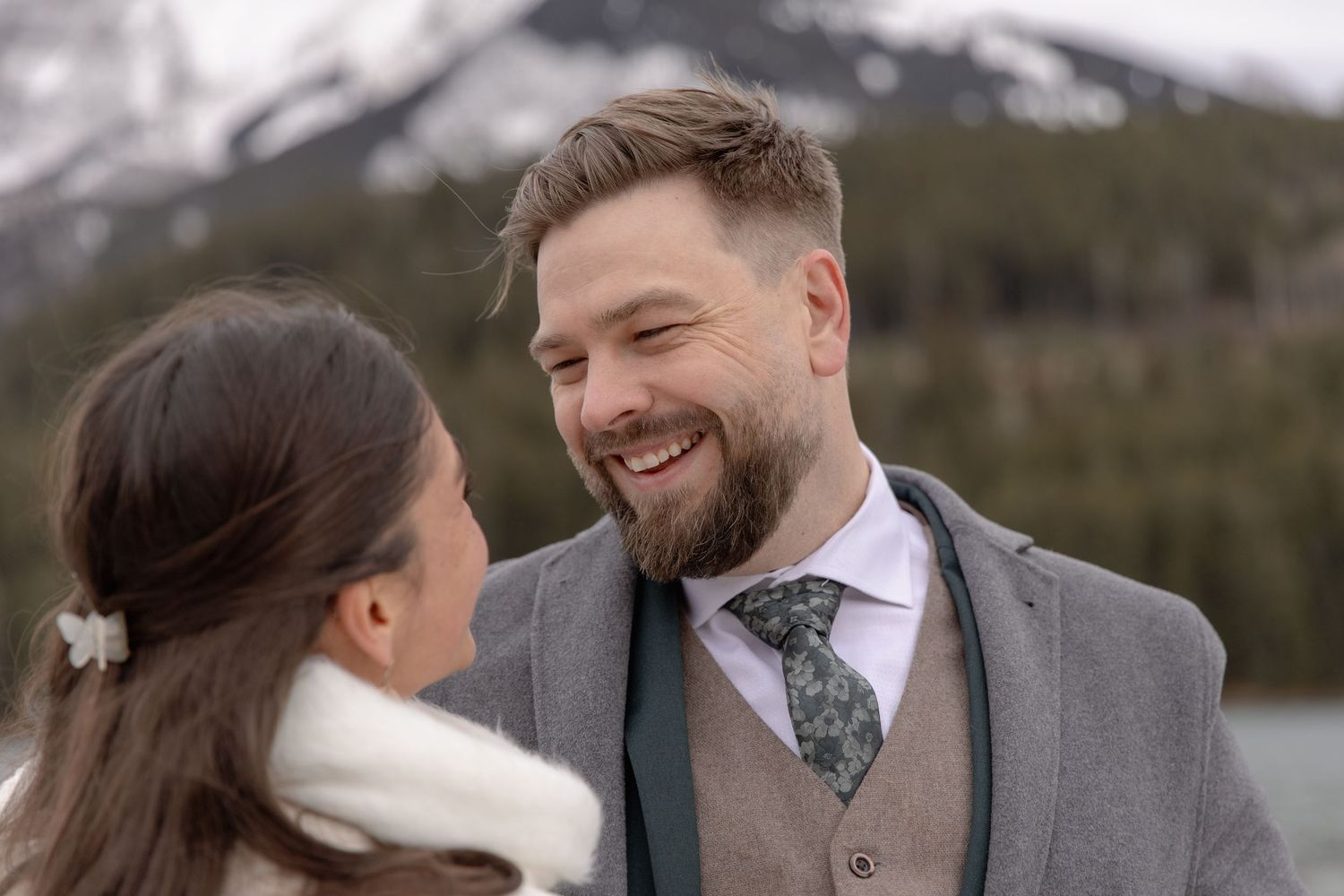 A happy couple shares intimate moments during their winter wedding photoshoot outdoors.
