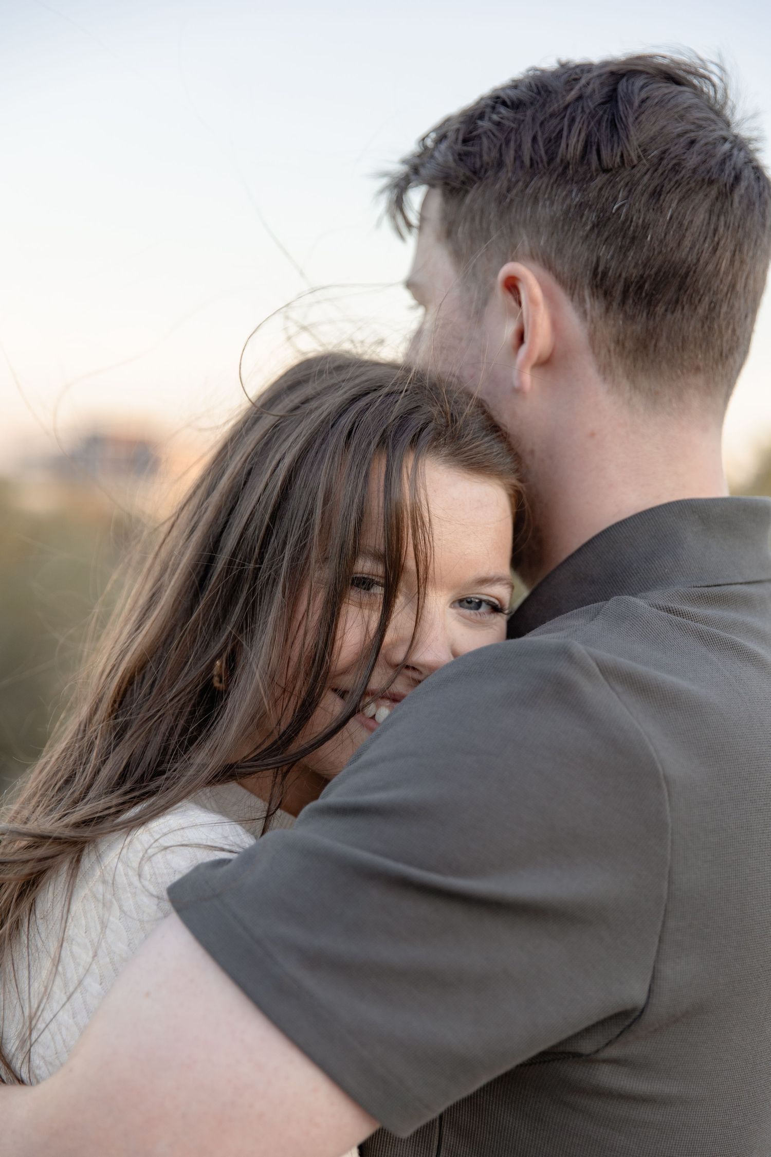 A romantic couple embraces in a series of intimate close-up shots during golden hour.