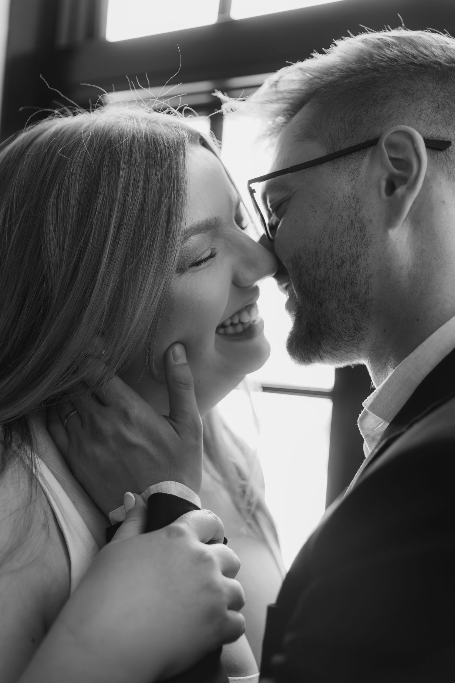 Black and white photo series showing intimate romantic moments between a couple in dramatic lighting.