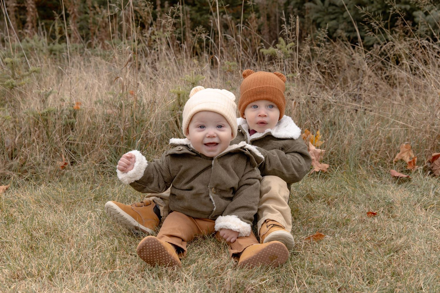 A series of seven sequential photos showing a baby in brown clothing rolling and playing on autumn grass.