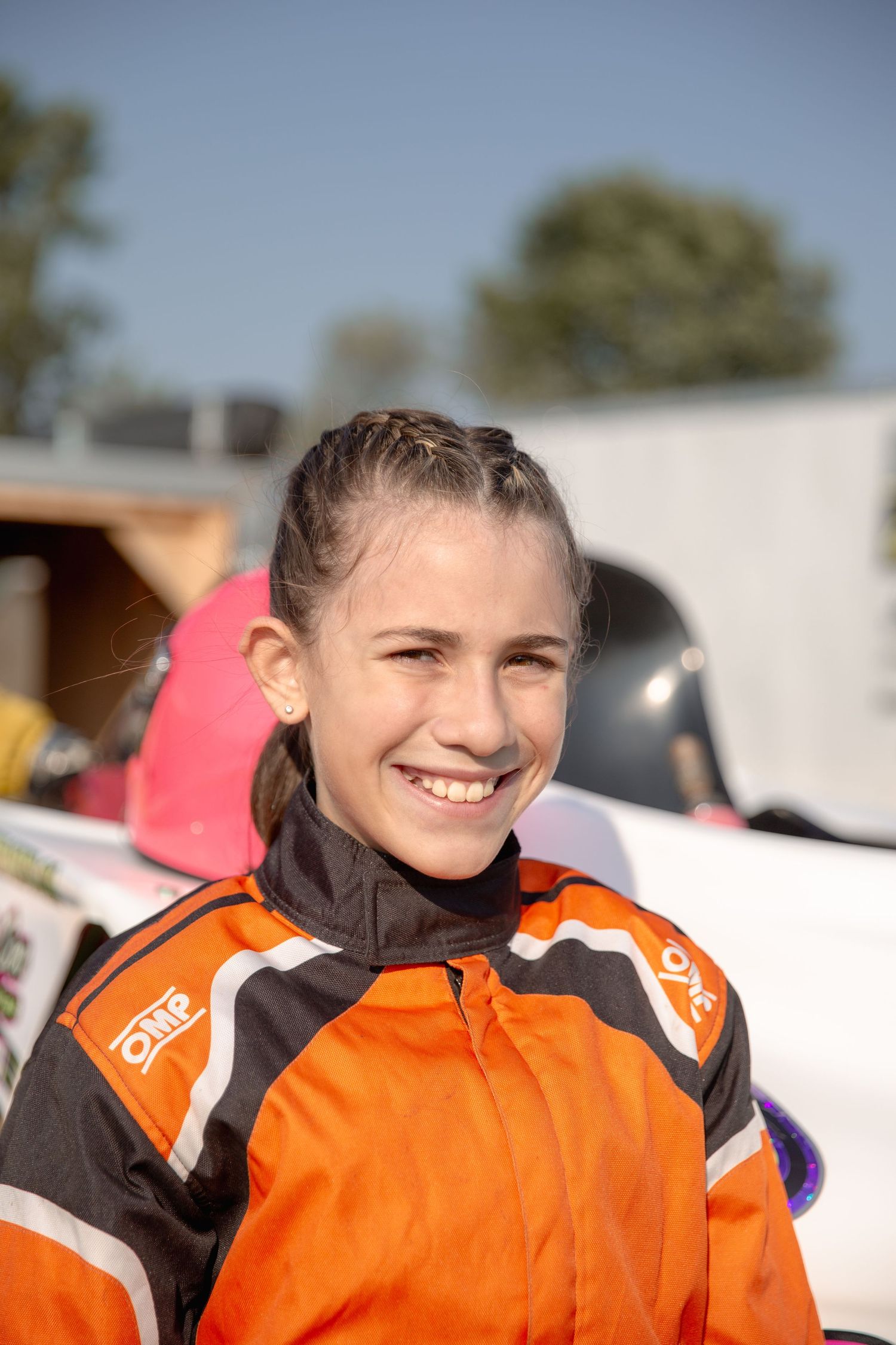 A series of photos showing someone wearing an orange and black winter sports uniform outdoors in snowy conditions.