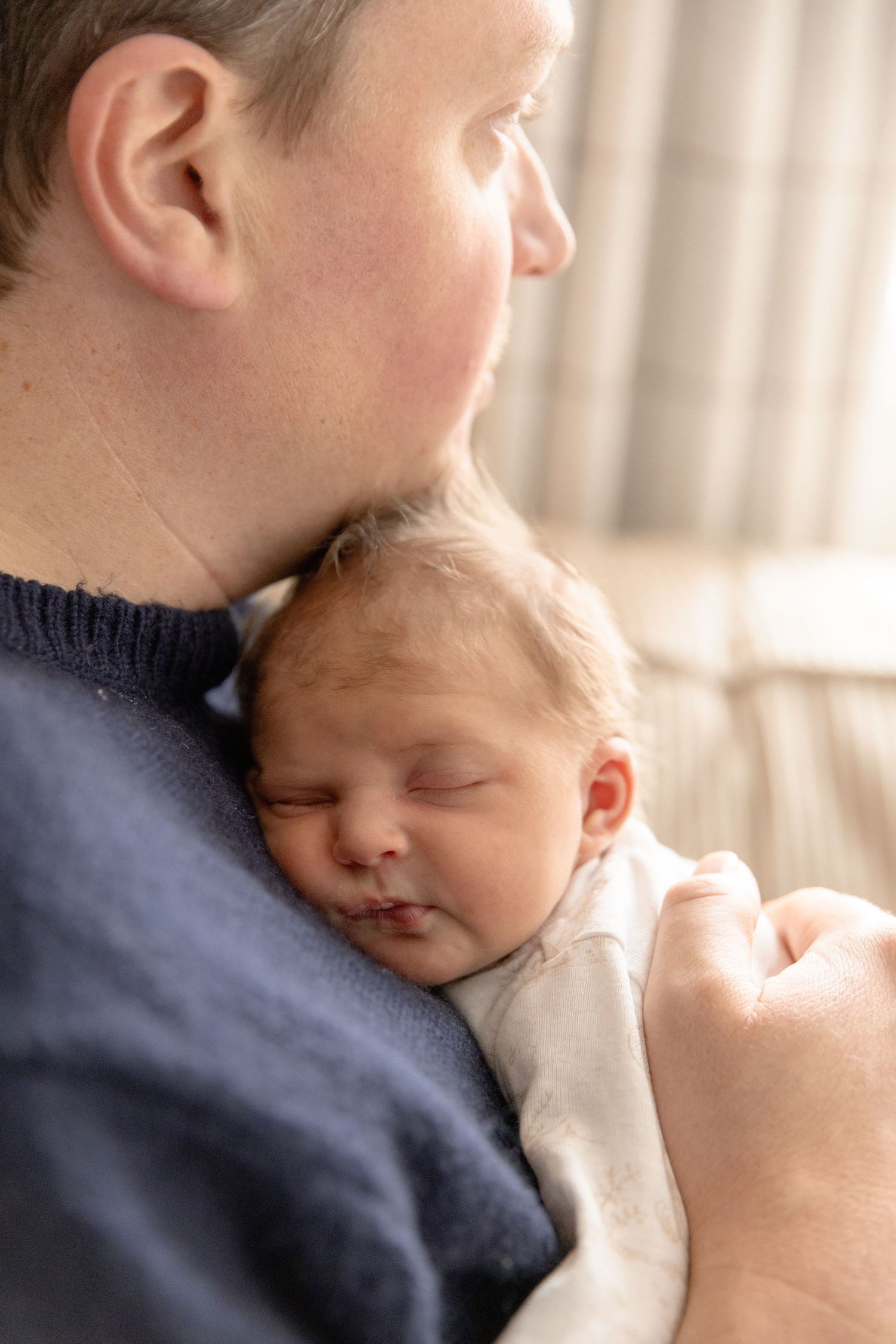 A sleeping baby rests peacefully on someone's shoulder in a series of tender close-up shots.