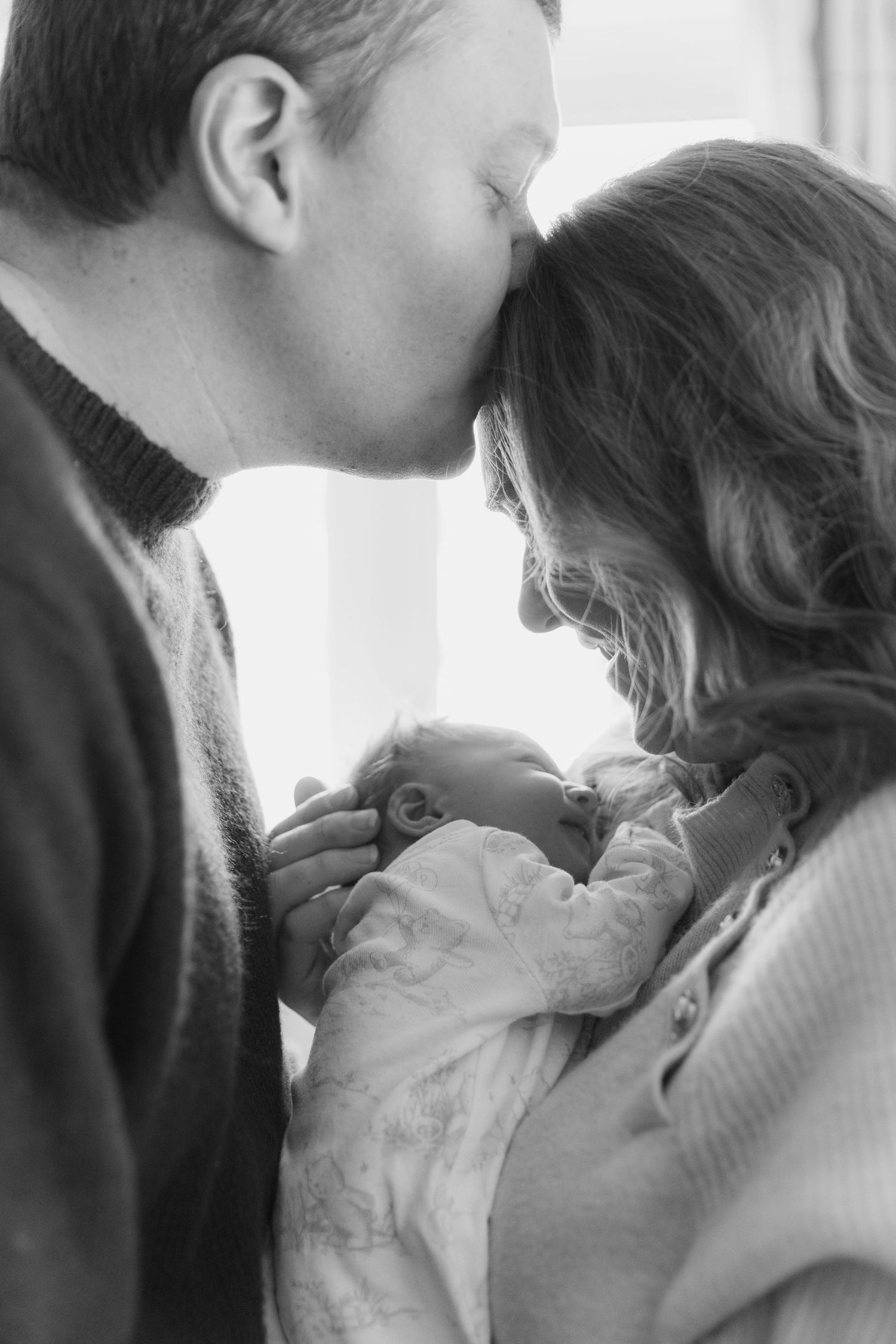 A tender black and white photo series showing a couple embracing and sharing intimate moments together.