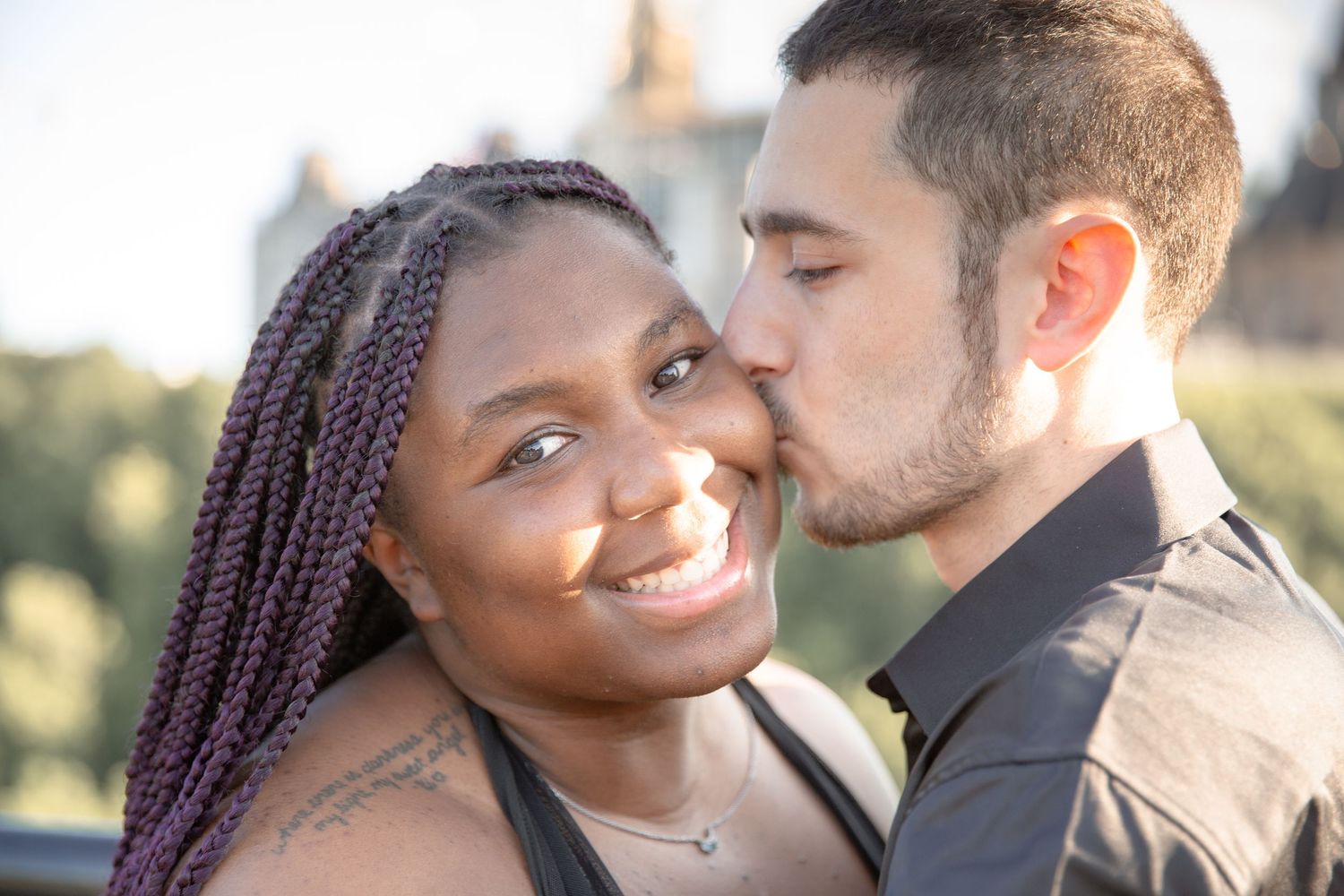 A couple shares an intimate moment together outdoors during a golden sunset photo session.