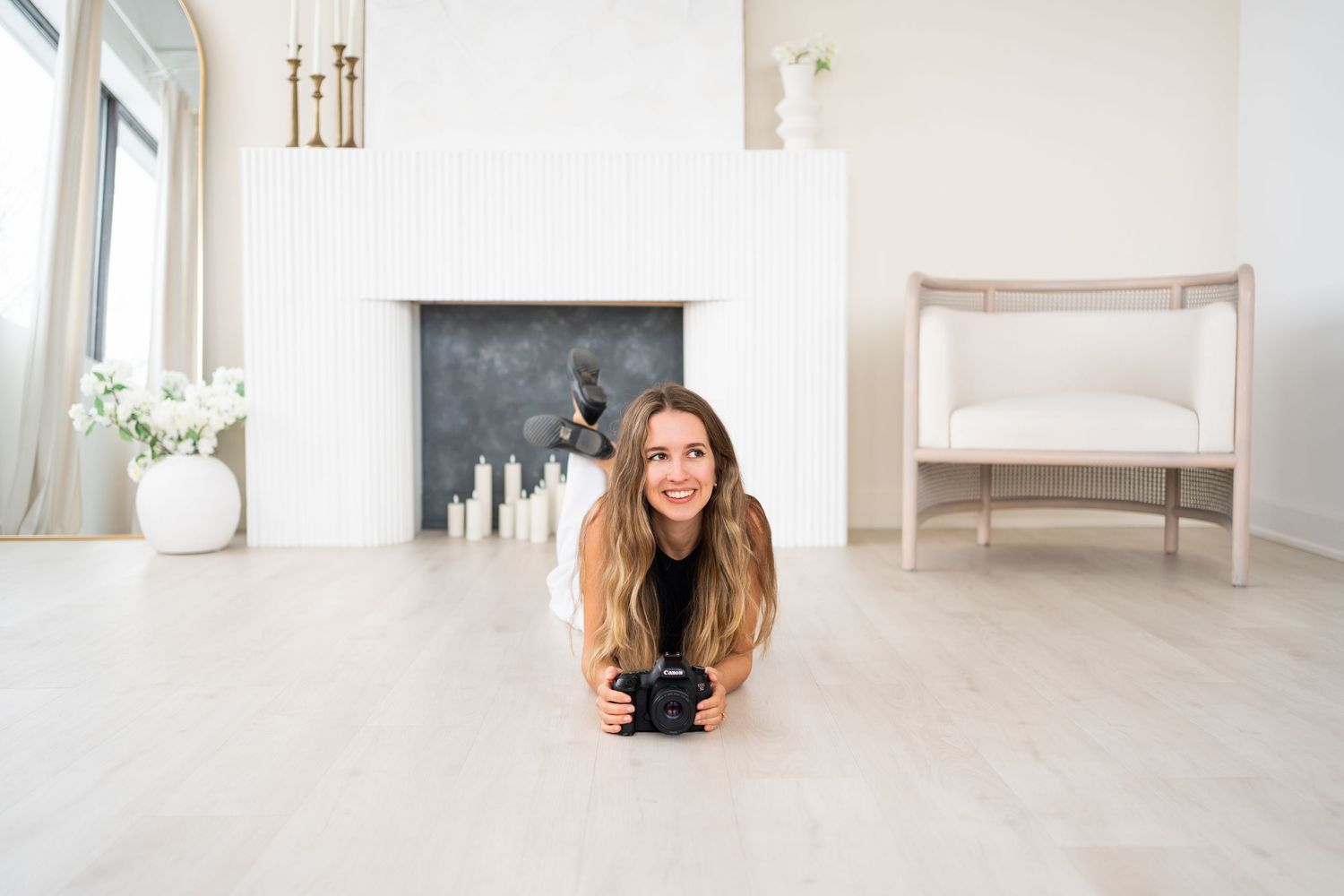 A minimalist white interior design room with light wood flooring and modern furnishings.