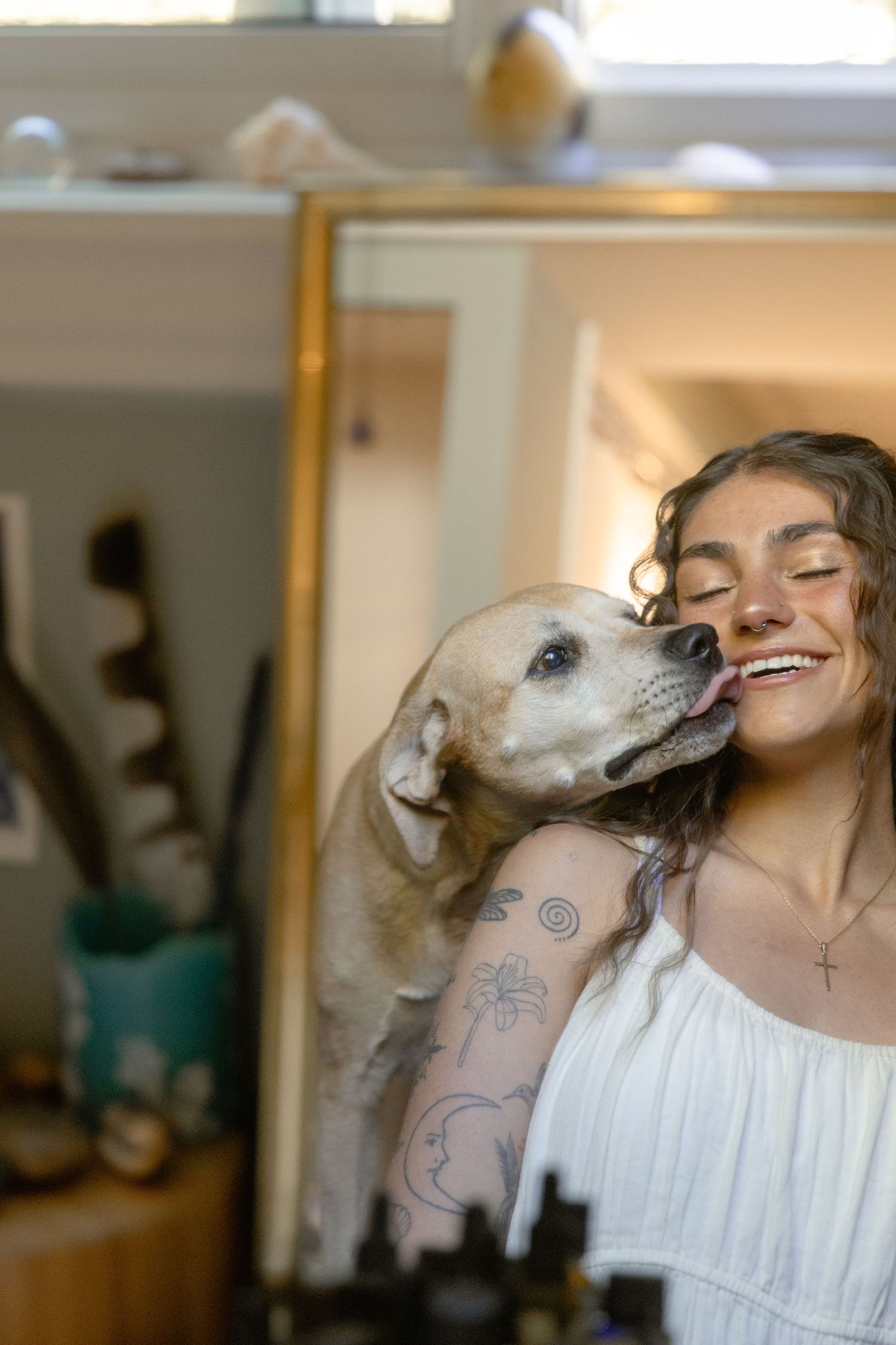A sweet moment captured as a white dog gives affectionate kisses in a sequence of candid photos.