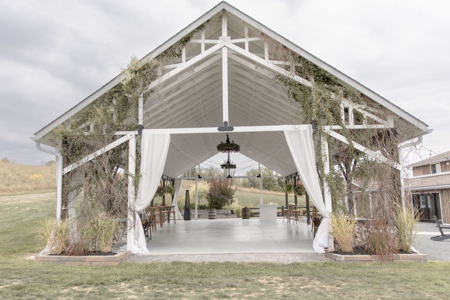 A series of architectural views showing the exterior angles and entrances of a modern white building structure.