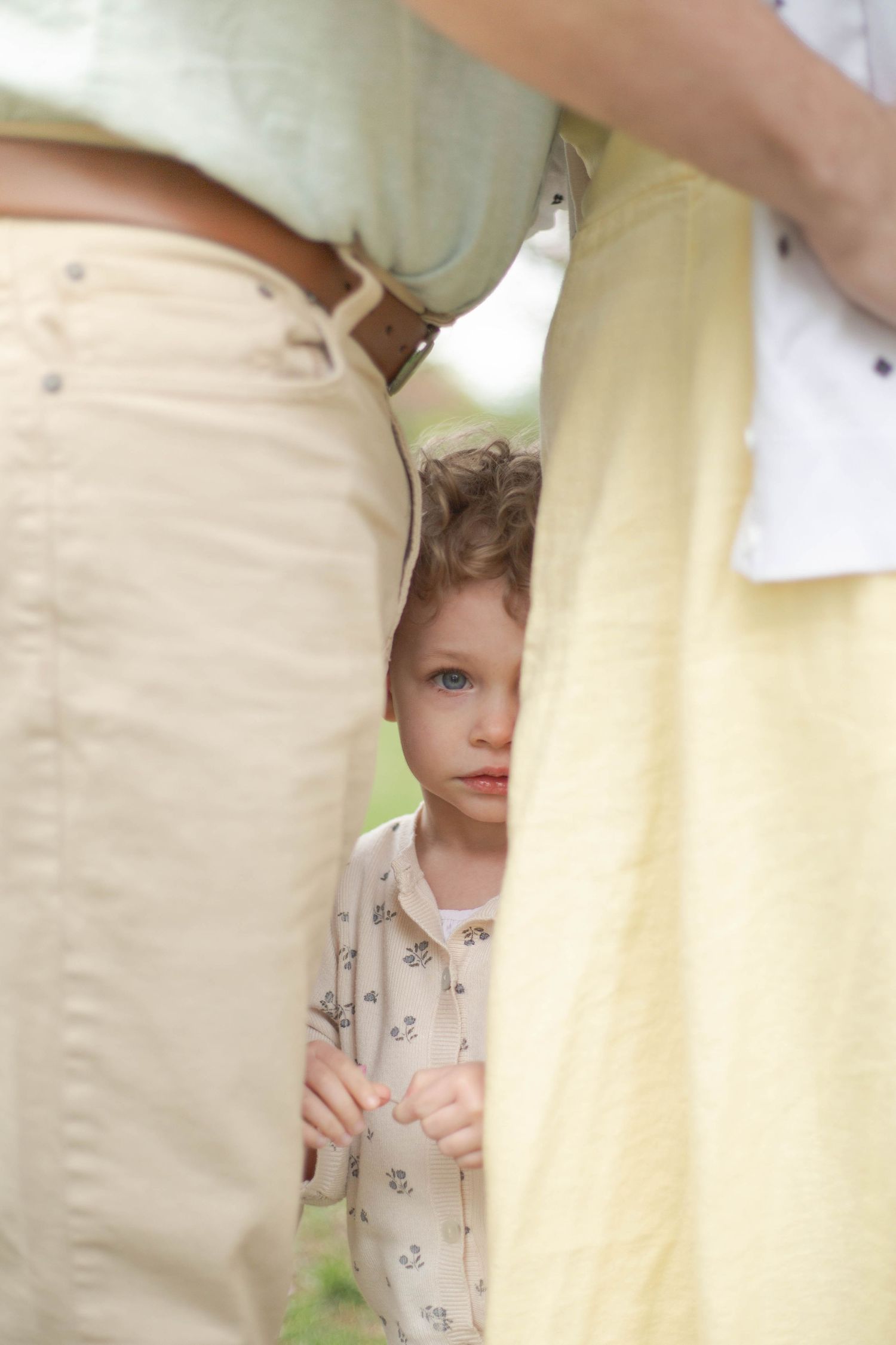 A sequence of photos showing someone peeking through a curtain in a playful hide and seek moment.