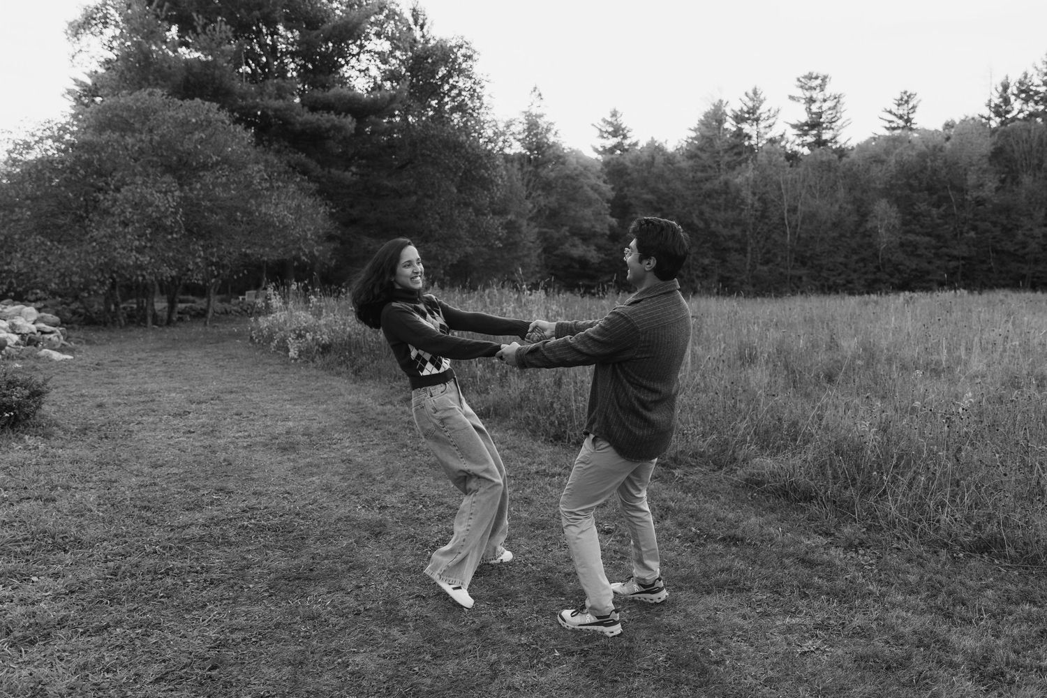 A sequence of black and white photos showing people swinging golf clubs on a grassy hill.