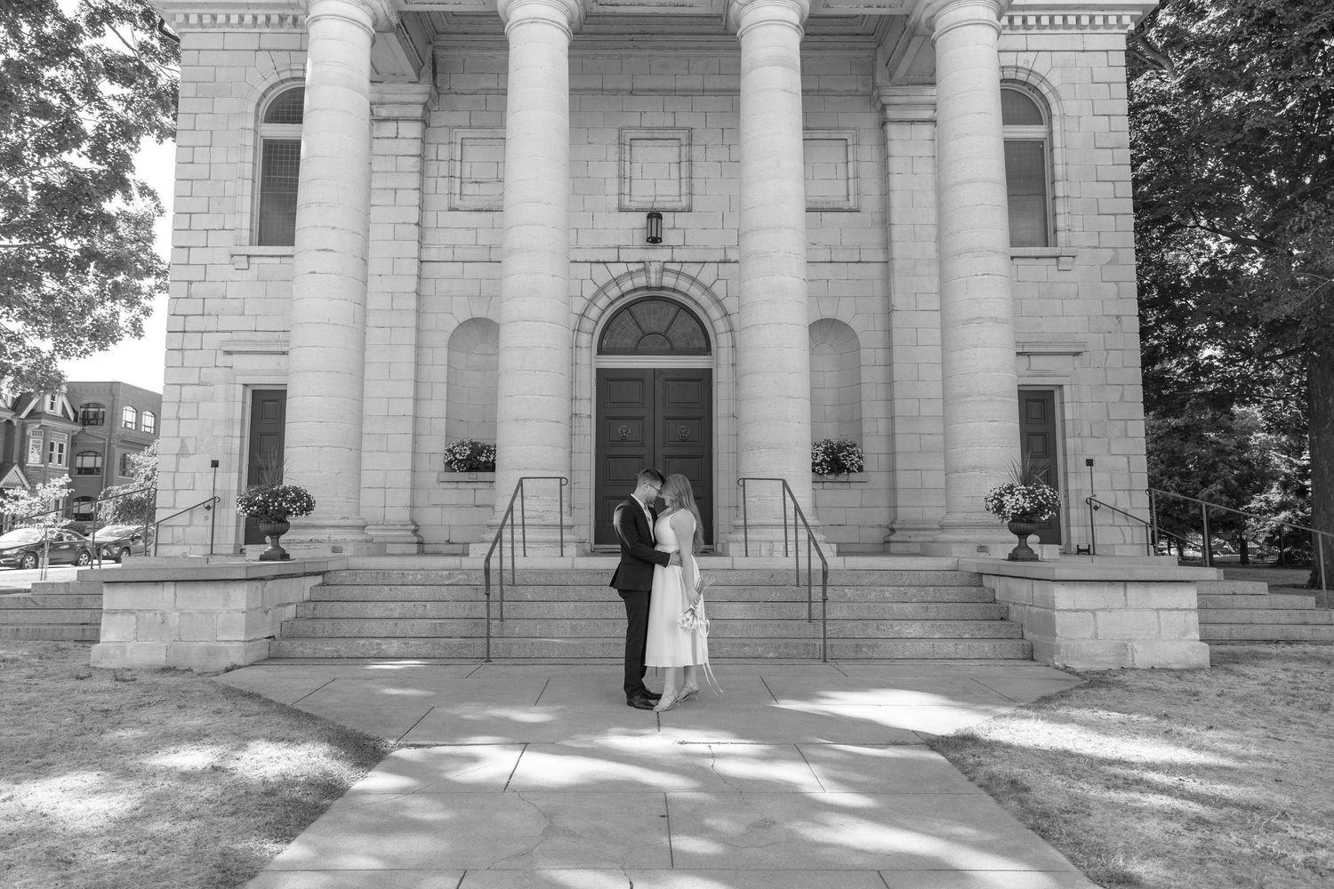 Church steps in black and white contrast showing columns and doorway with fading gradient.