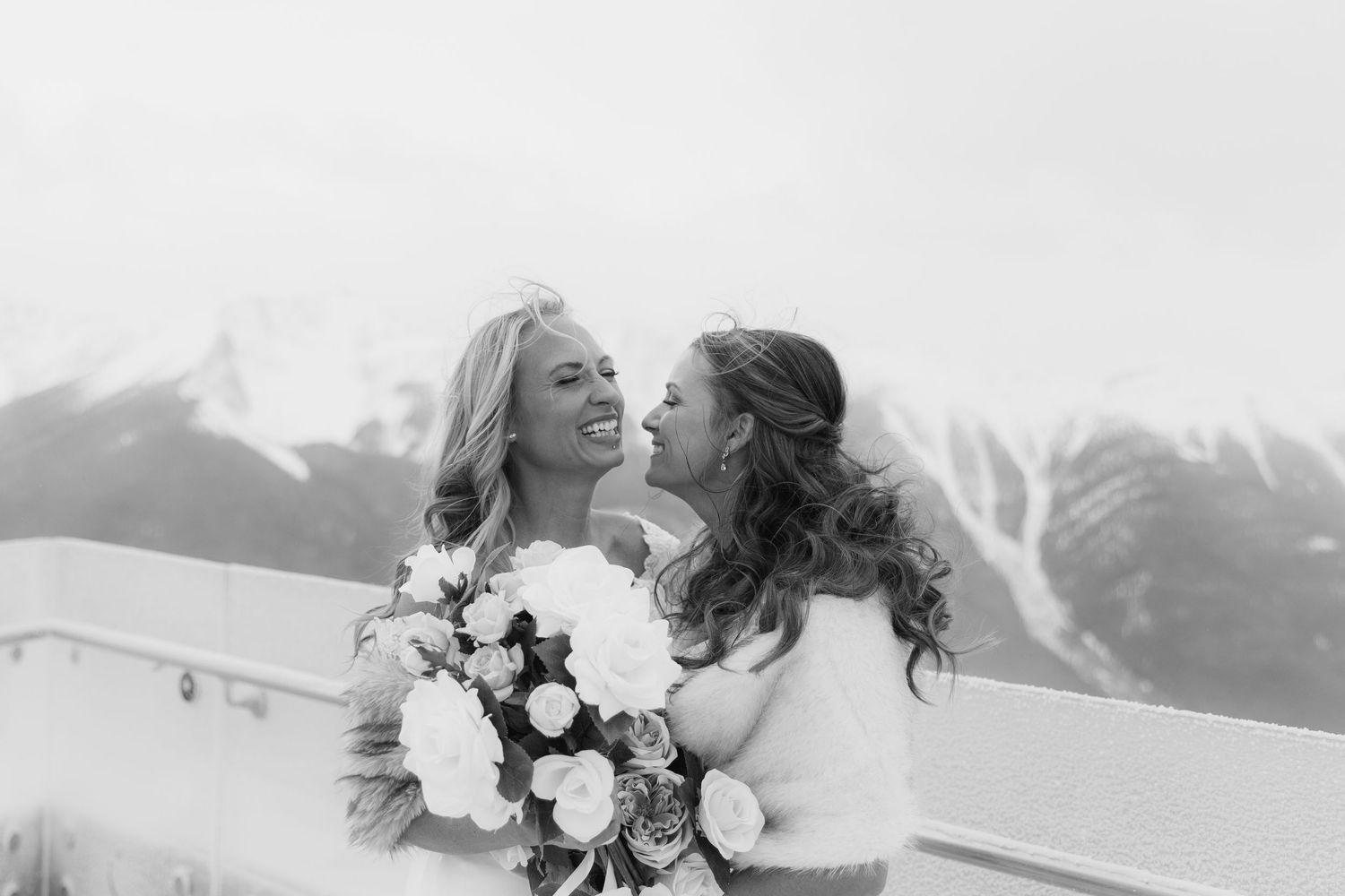 A romantic winter wedding scene with snow-capped mountains in the background and a beautiful floral bouquet in the foreground.