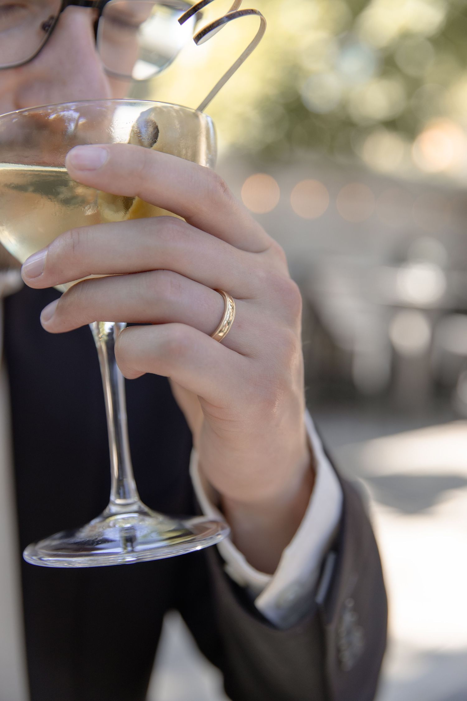 Close-up of hands holding champagne glasses during wedding celebration.