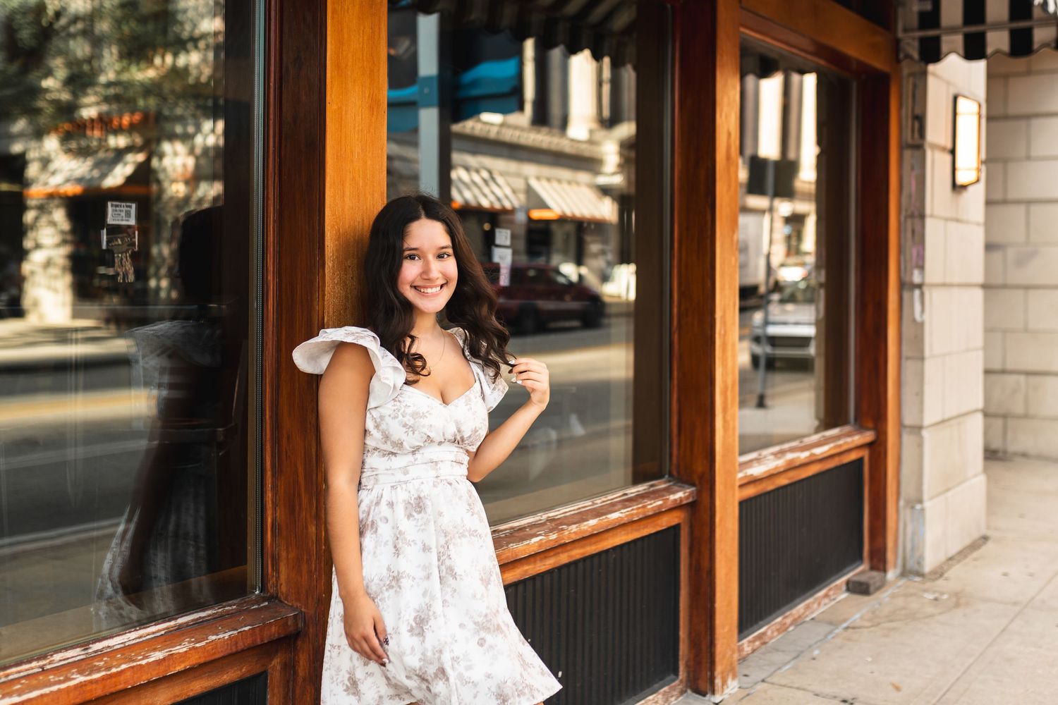 A portrait of a senior girl smiling for a photo in downtown Grand Rapids, MI.