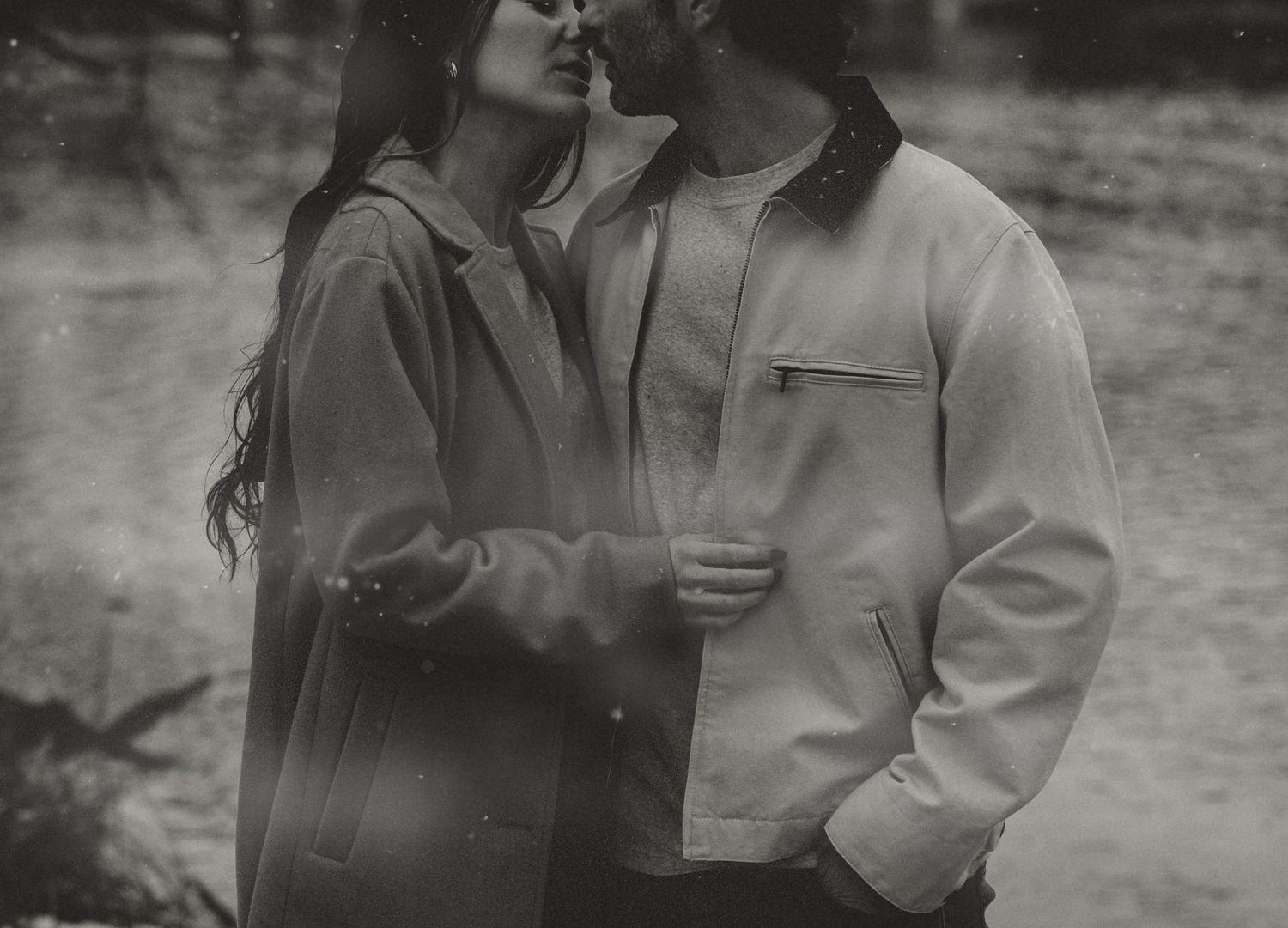 A romantic black and white photo series showing a couple in intimate conversation outdoors.