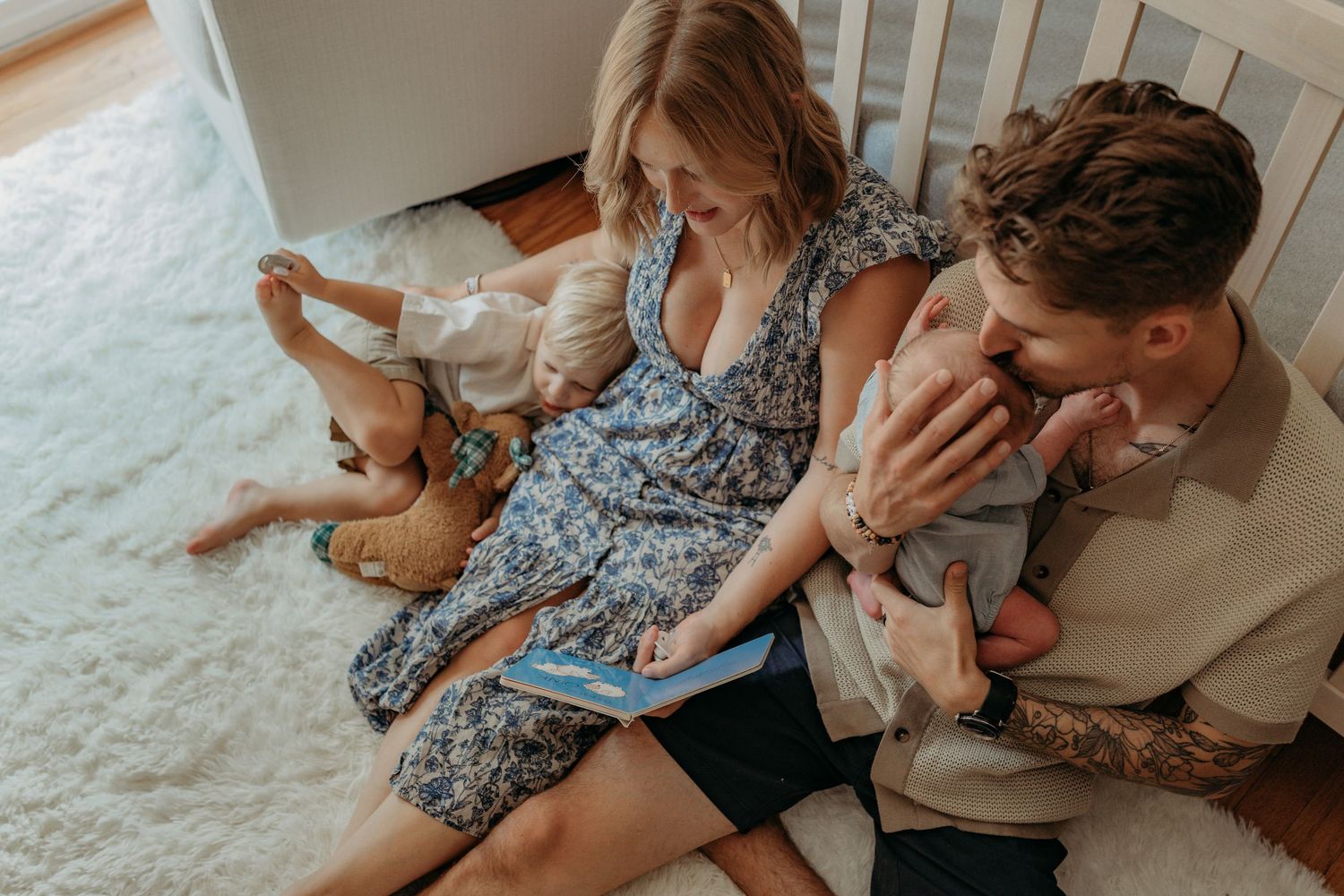A couple sits together intimately on a white carpet while sharing tender moments in multiple candid photos.
