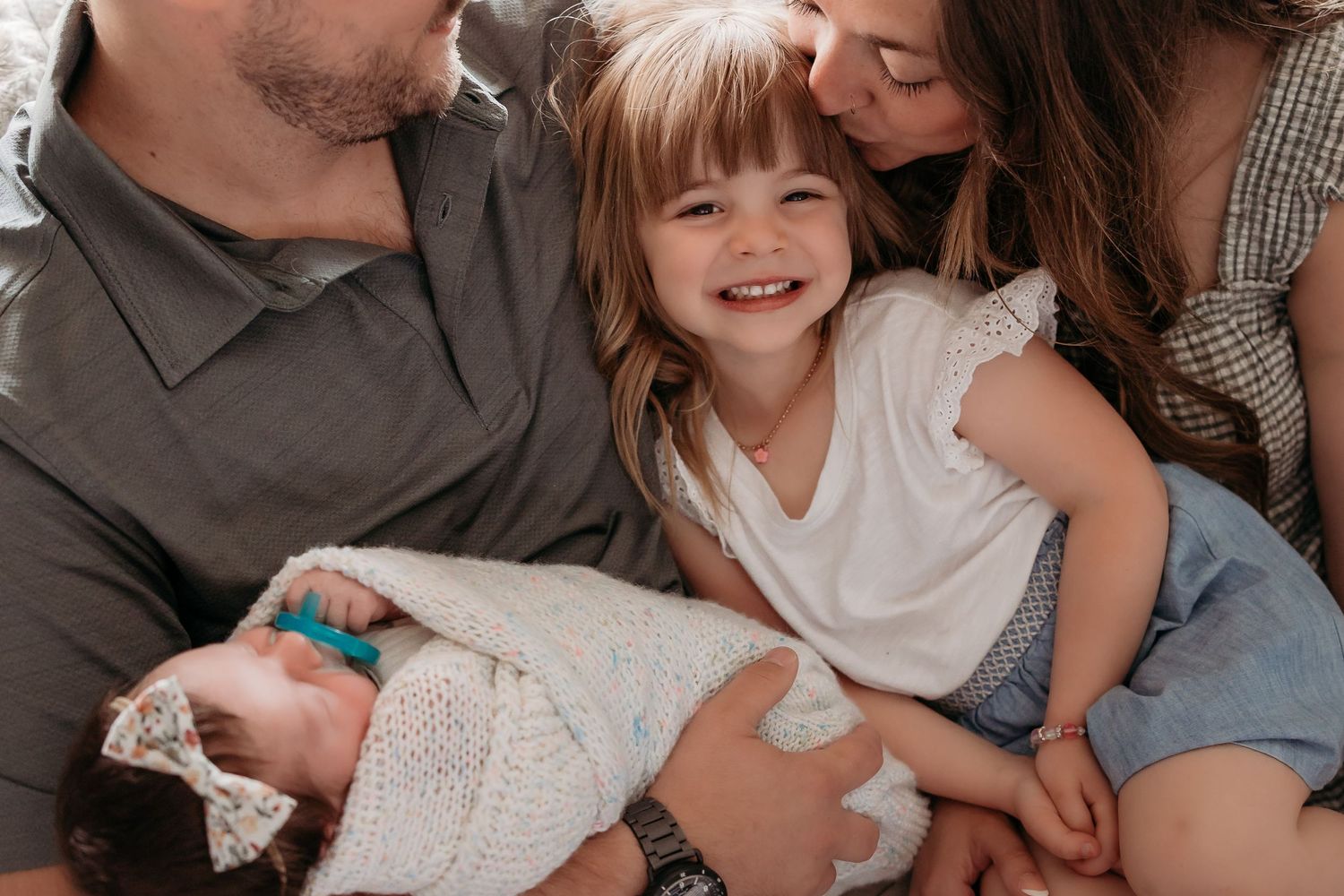 Seven images of connected photo strips show smiling loved ones in a cozy indoor setting during a special occasion.