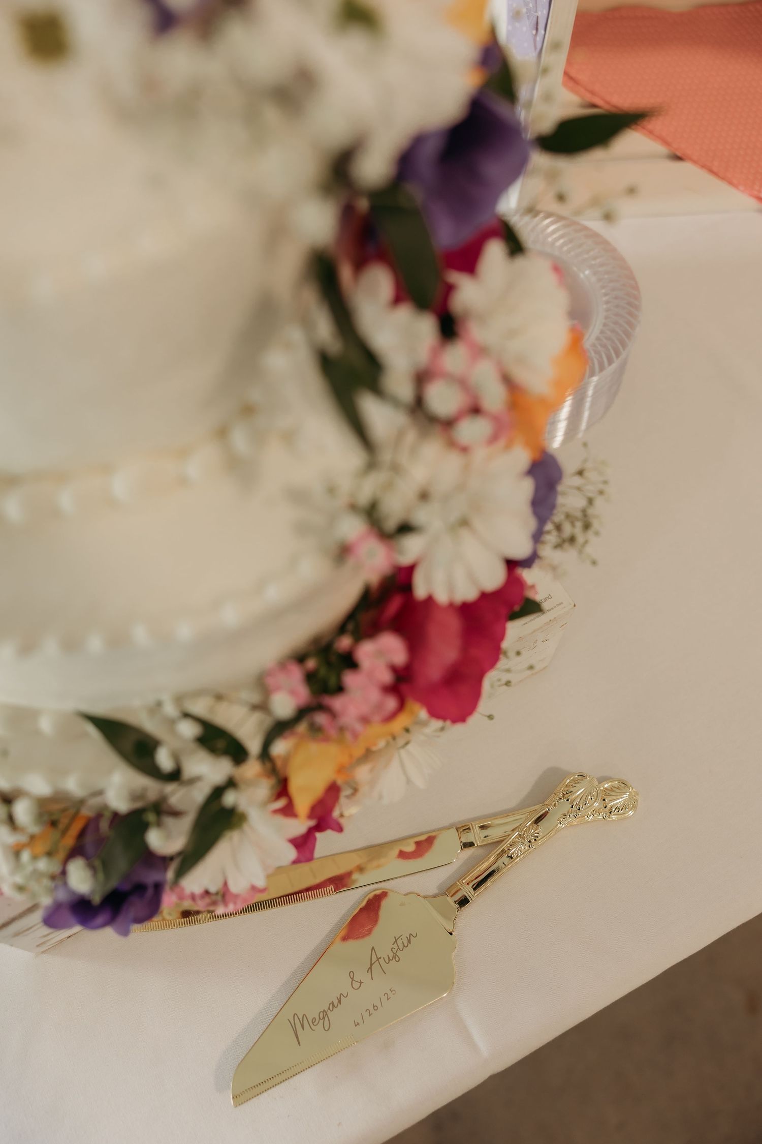 White ceramic plates adorned with colorful flower arrangements featuring purple, pink and orange blooms against a soft background.