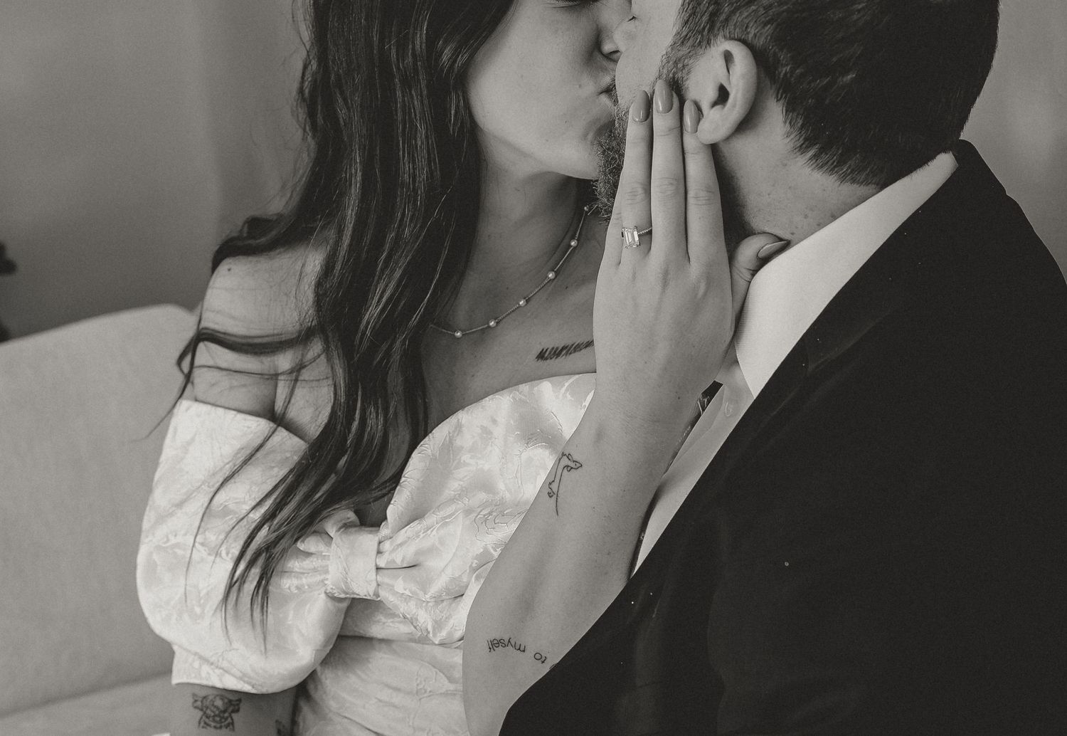 A romantic black and white photo series showing a couple embracing and kissing in intimate poses.