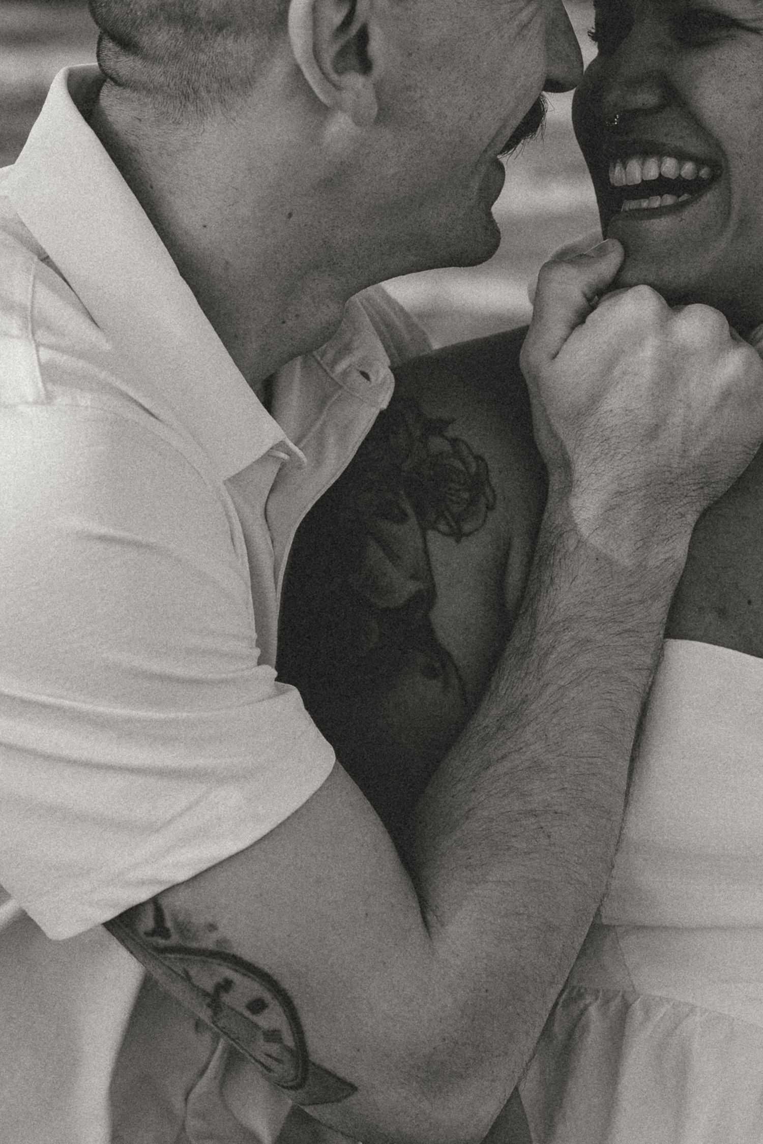 A black and white photo sequence shows a couple in an intimate embrace, with one wearing white and the other in gray.