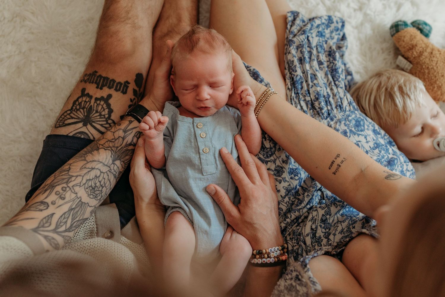Close-up collection of tender moments between parent and baby in soft blue and neutral tones.