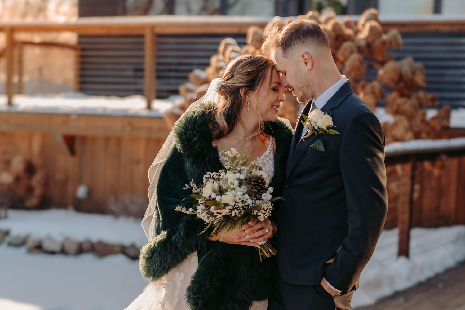 Romantic winter engagement photos showing couples sharing intimate moments at a rustic outdoor venue.