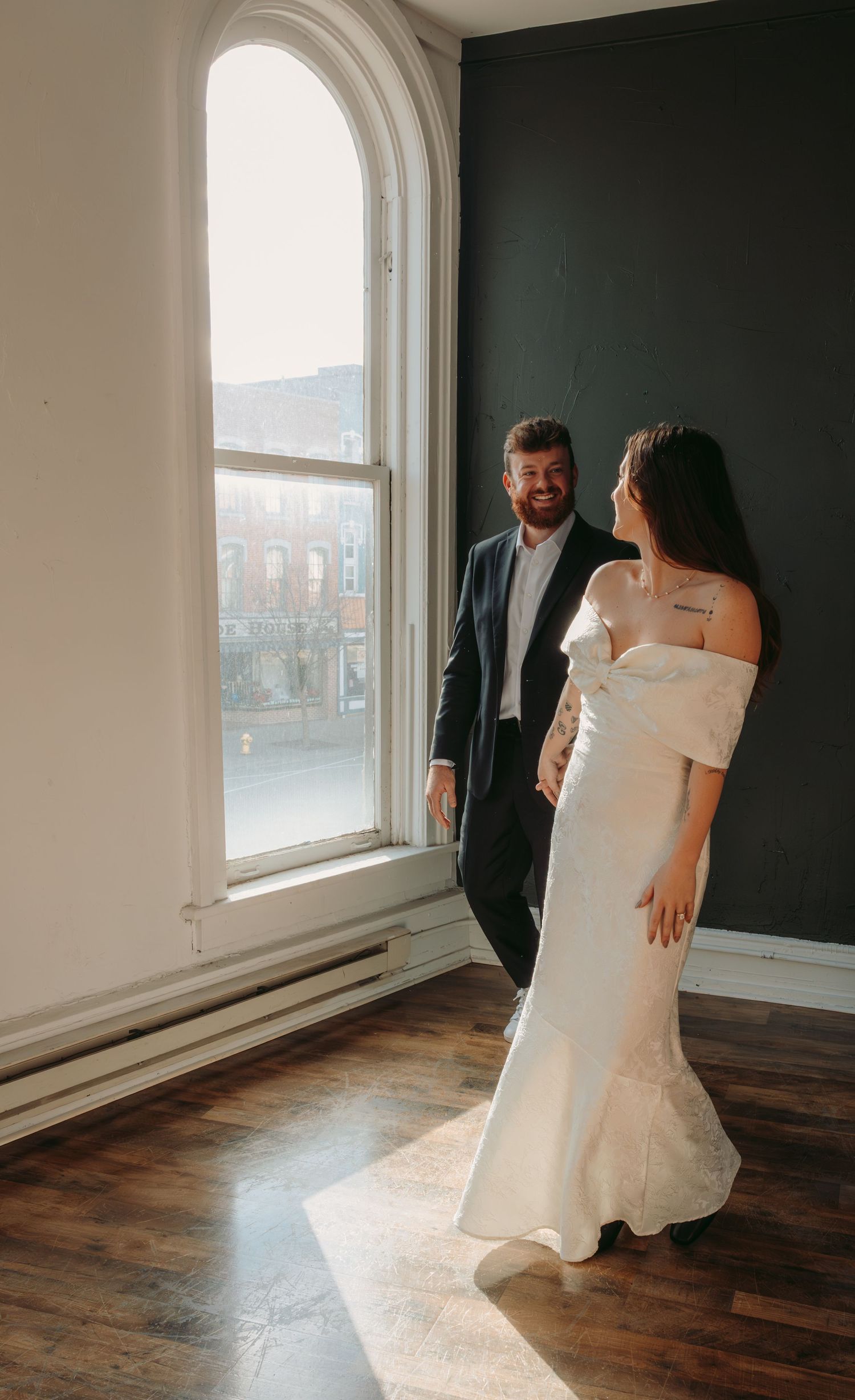 A sequence of artistic photos showing a figure in white clothing moving through sunlit room with wooden floors and arched windows.