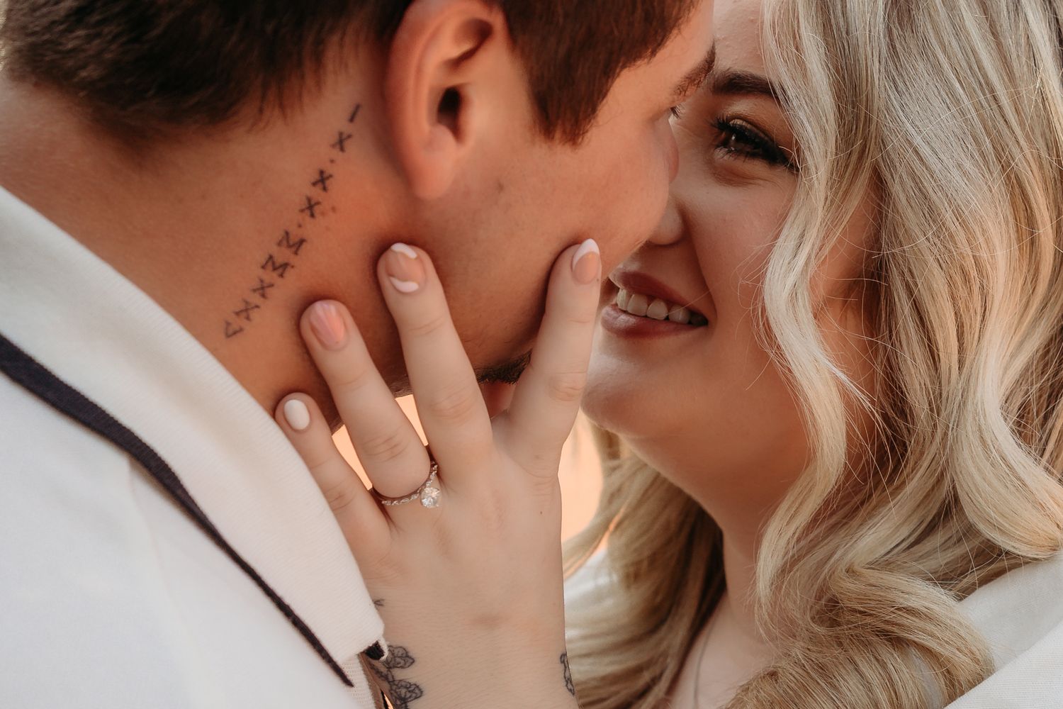 Close up intimate photos showing tender moments between a couple with blonde hair.