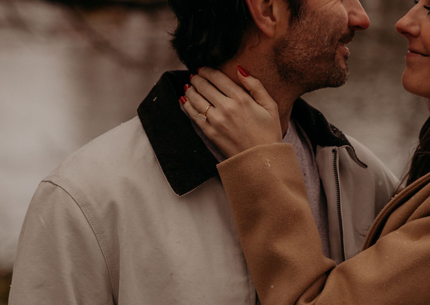 Close up photo of two people in intimate embrace with soft warm lighting and romantic mood.