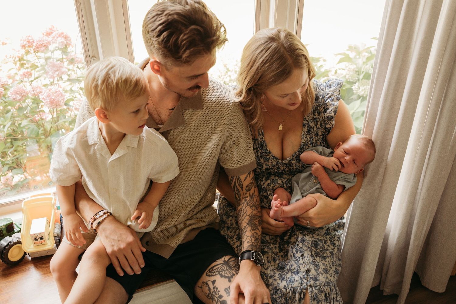 A collection of candid family photos showing intimate moments together on a couch by a window.