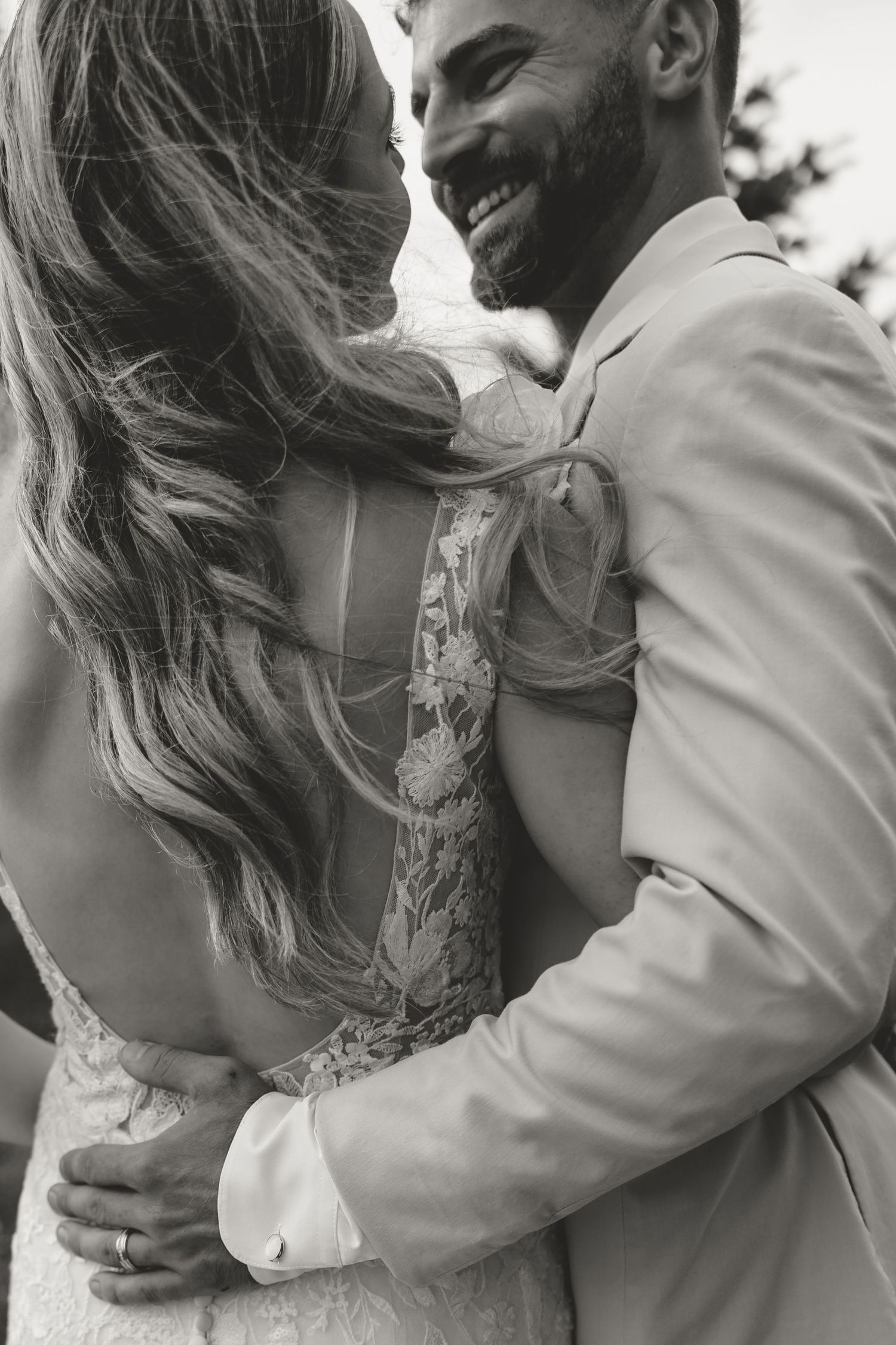 Black and white collage series of romantic wedding moments showing a couple embracing in heartfelt emotion.