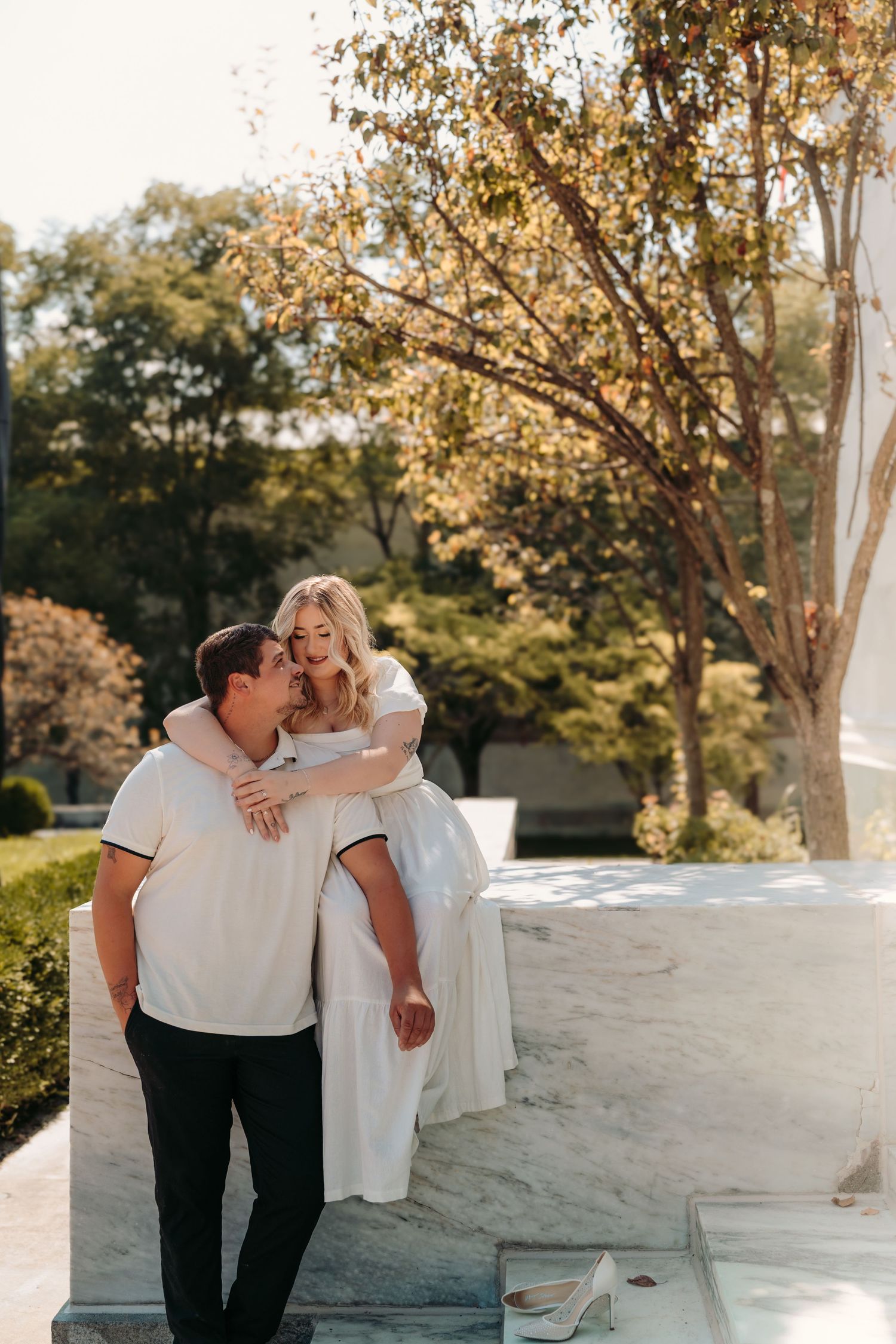 A romantic outdoor photoshoot showing three candid moments of a couple embracing in warm sunlight.