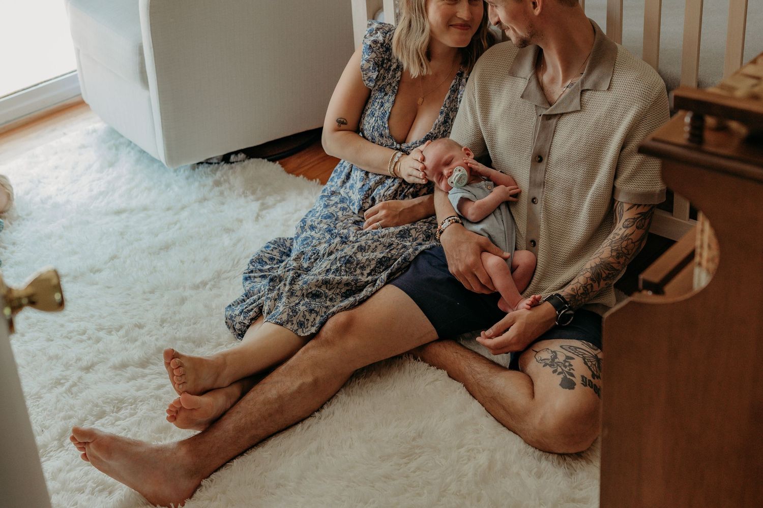 Intimate indoor family portrait session showing loving interactions in warm natural light.