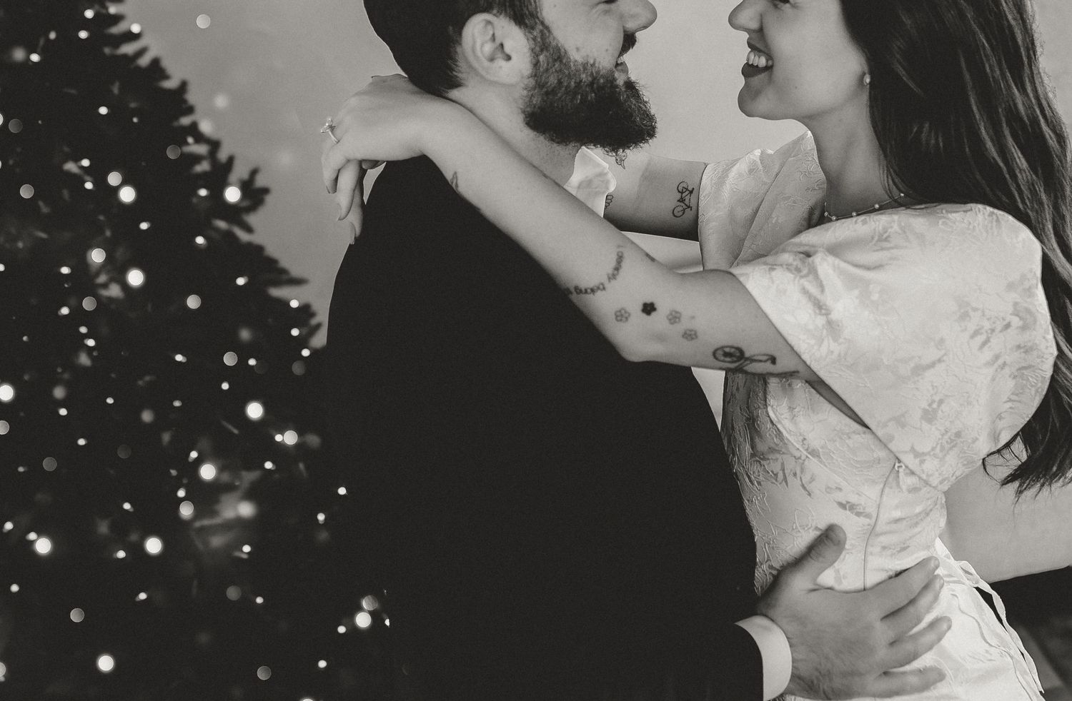 A romantic black and white photo series showing a couple embracing and dancing in falling snow.