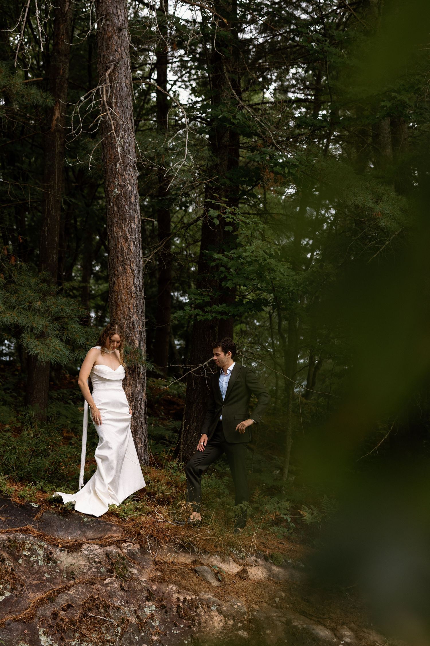 Wedding photography session in a moody pine forest setting.
